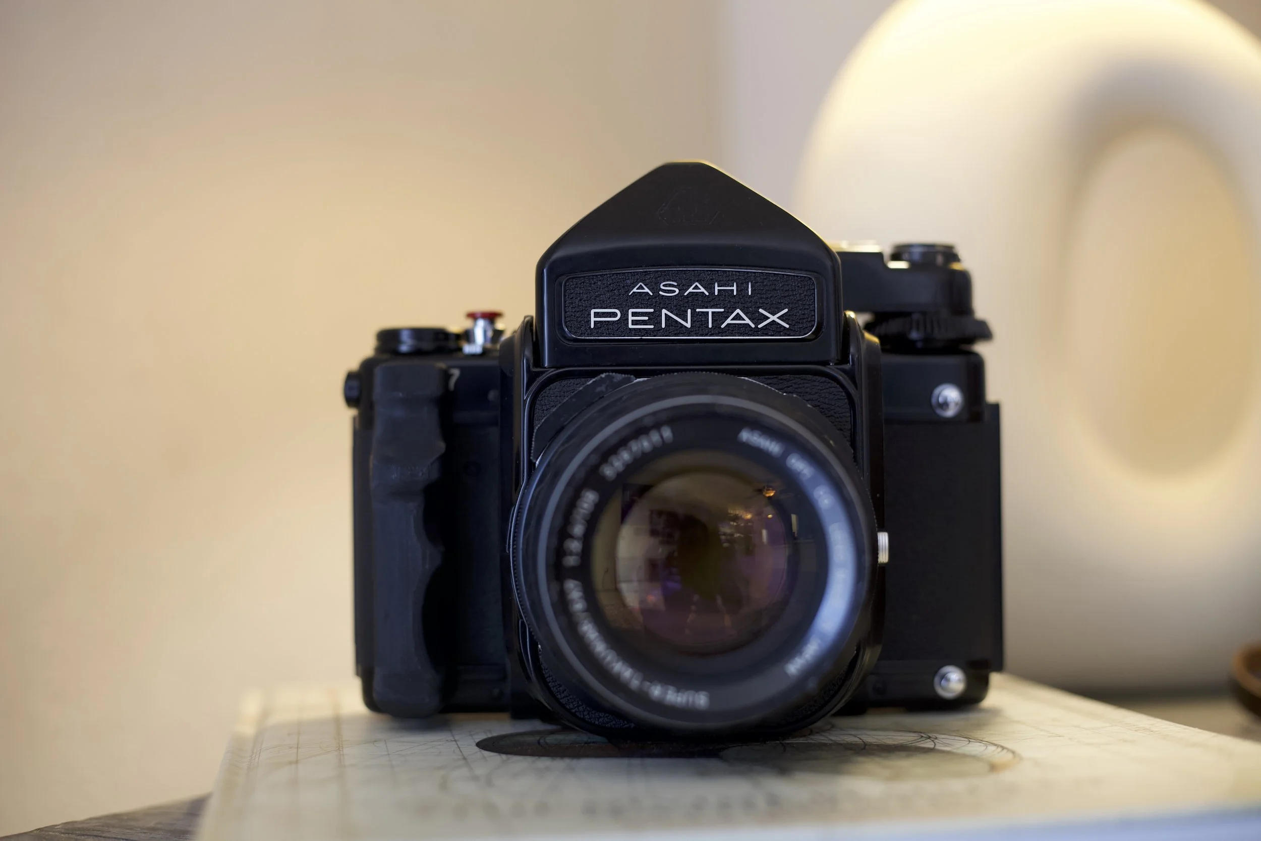 Front view of a vintage Asahi Pentax camera with a lens facing forward.