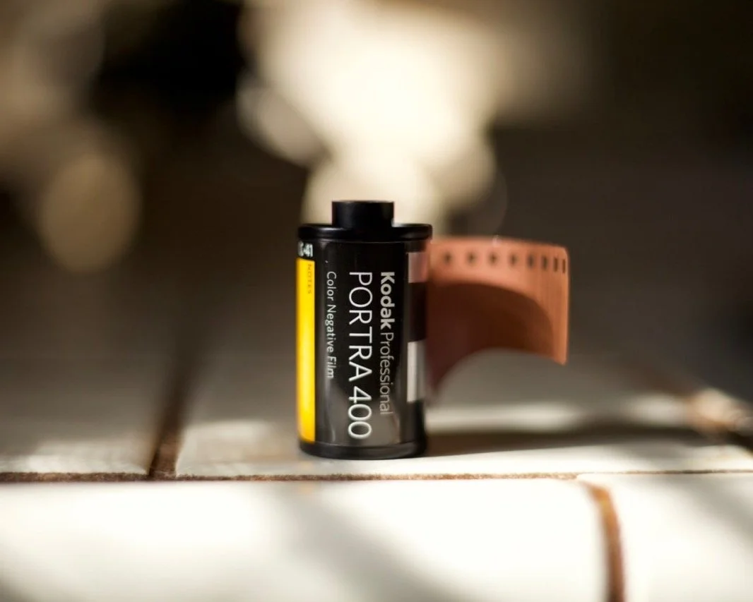 35mm film roll with yellow label on white background