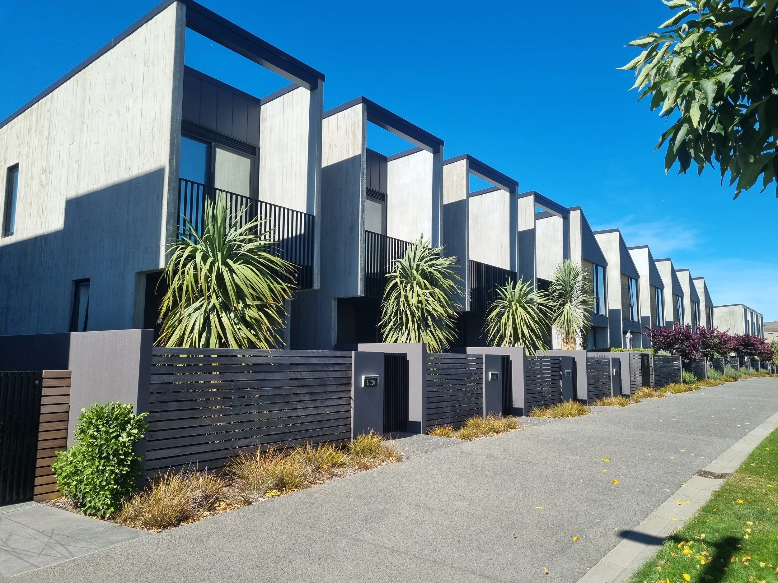 Modern apartment building in central Christchurch with large balconies overlooking Rauora Park.