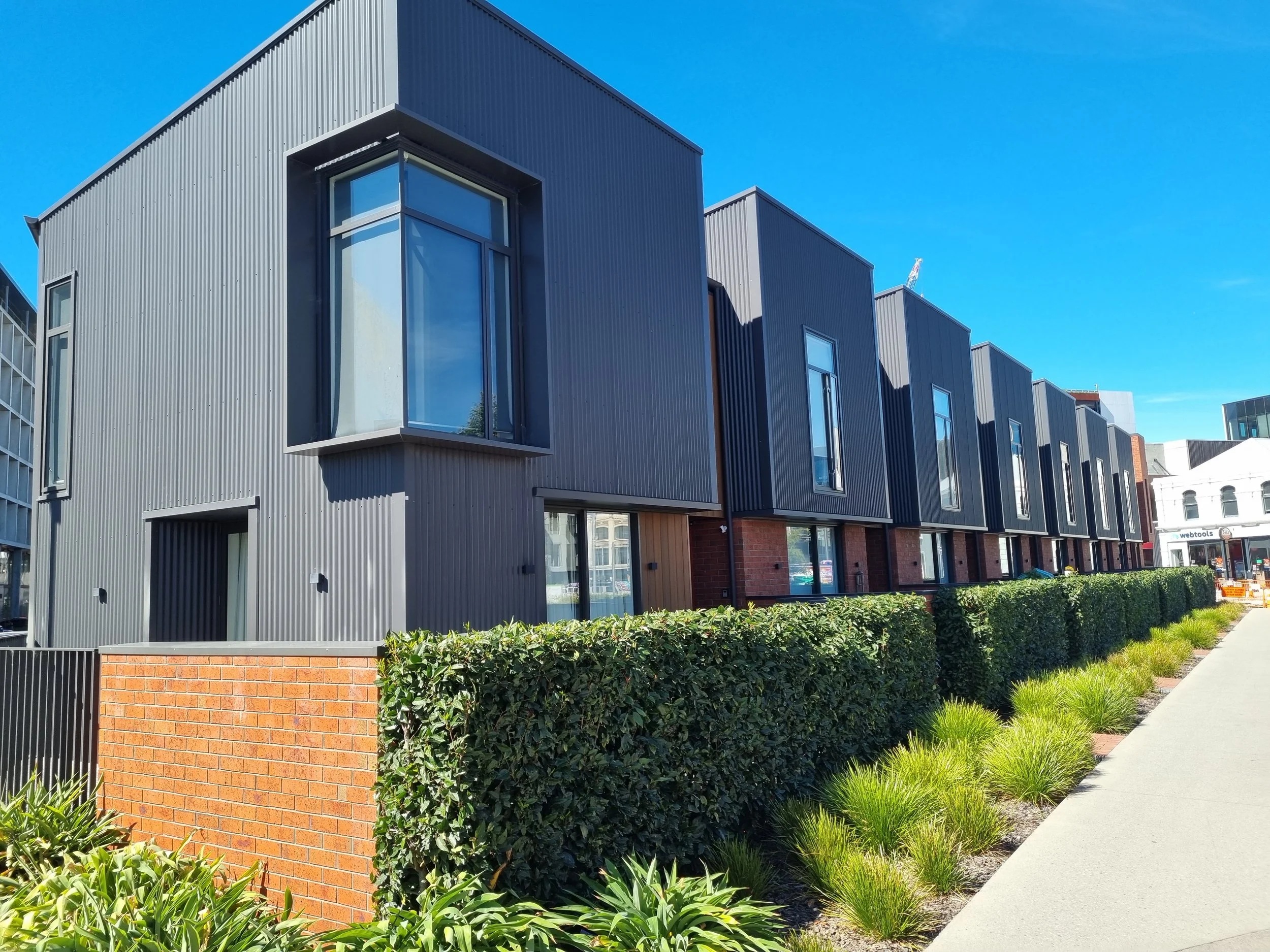 Modern apartment in central Christchurch with manicured gardens.
