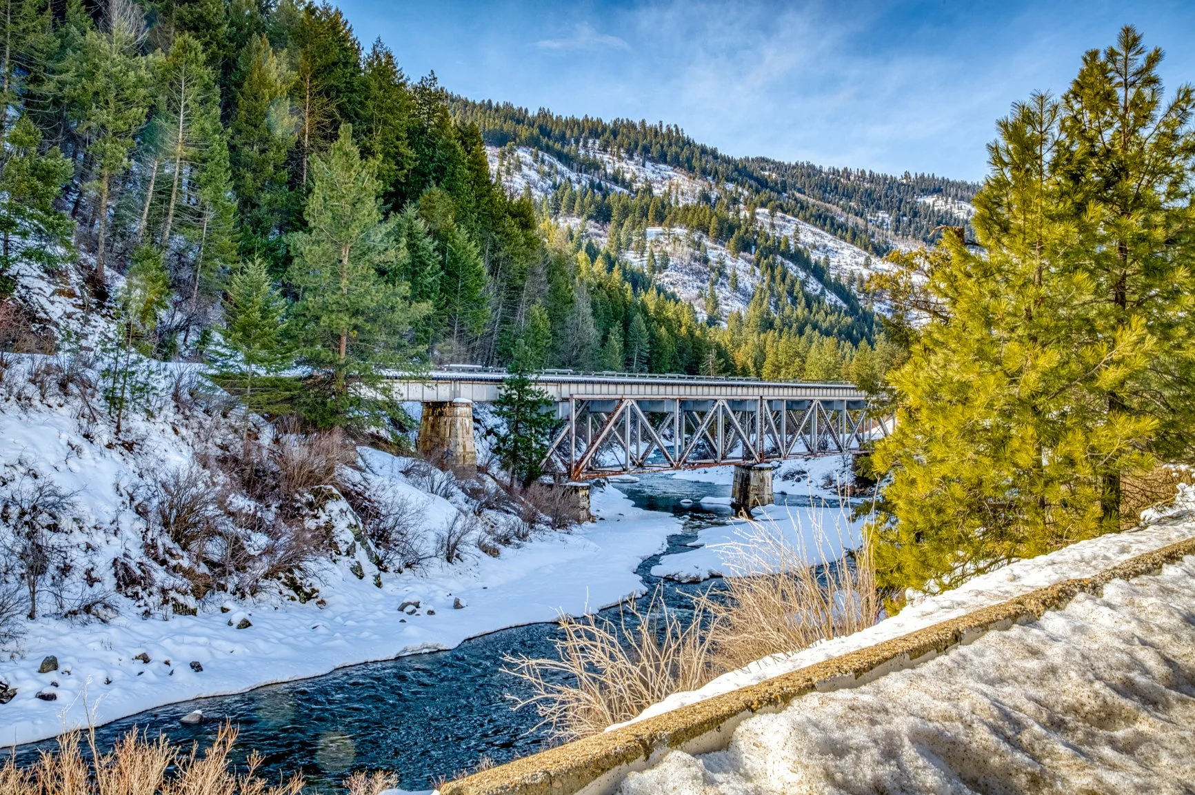 Highway 55, Payette River, steel truss bridge, Idaho bridge, winter landscape, snowy mountains, frozen river, winter river, pine forest, evergreen trees, Idaho scenery, mountain road, rugged landscape, American Northwest, winter travel, river crossin