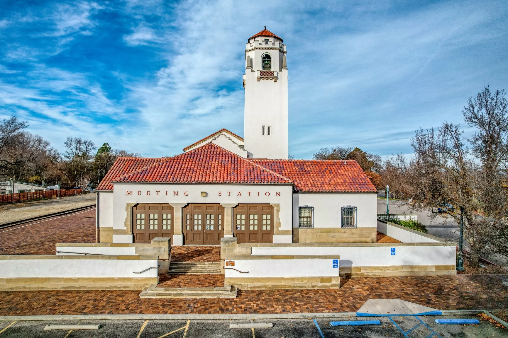 Viewed from the Meeting Station side, the Boise Train Depot stands as a timeless symbol of the city’s railroad heritage. Its white stucco walls, red tile roof, and soaring clock tower reflect classic Spanish Revival architecture, beautifully framed b