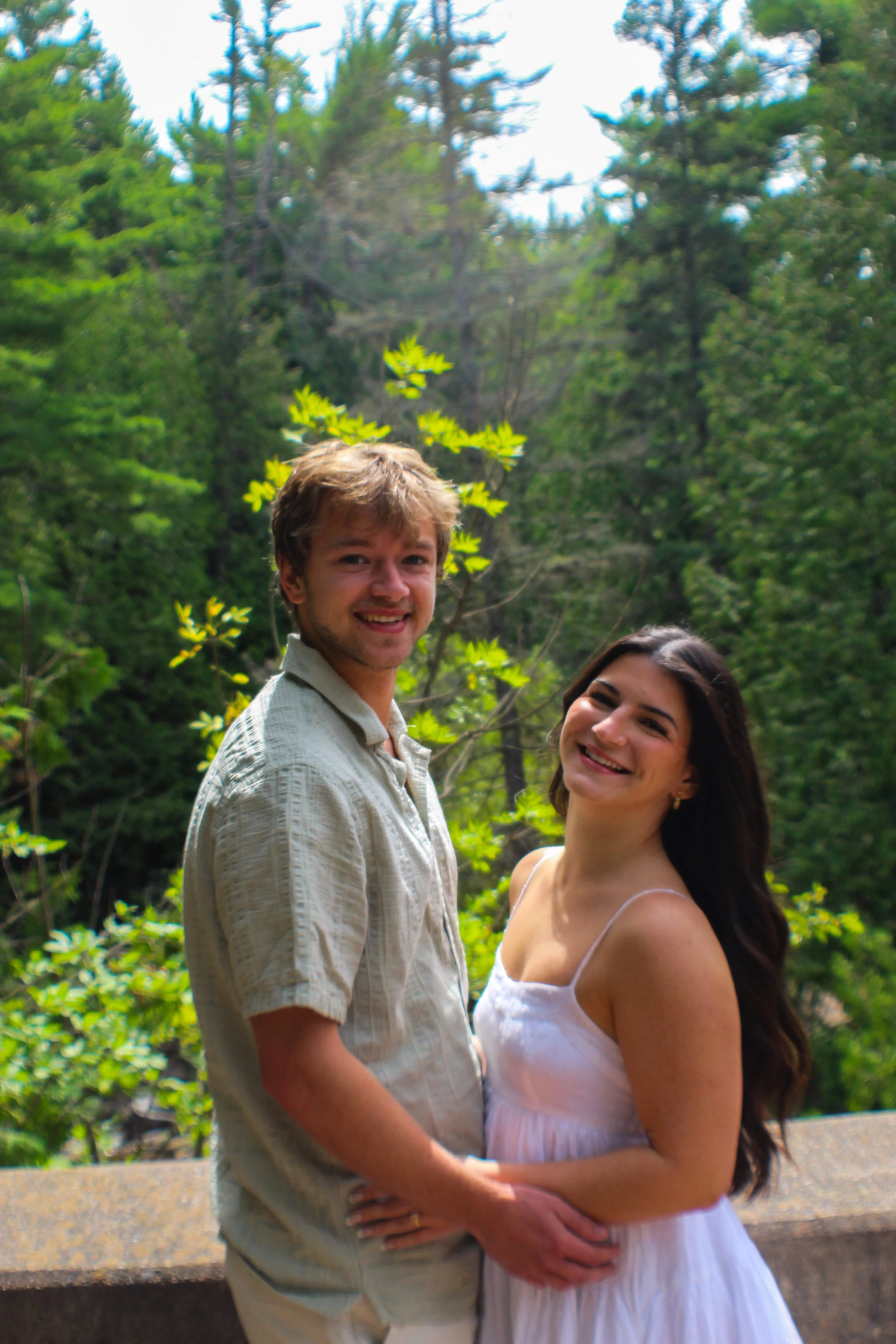 couple standing in front of a waterfall taken by atika goble