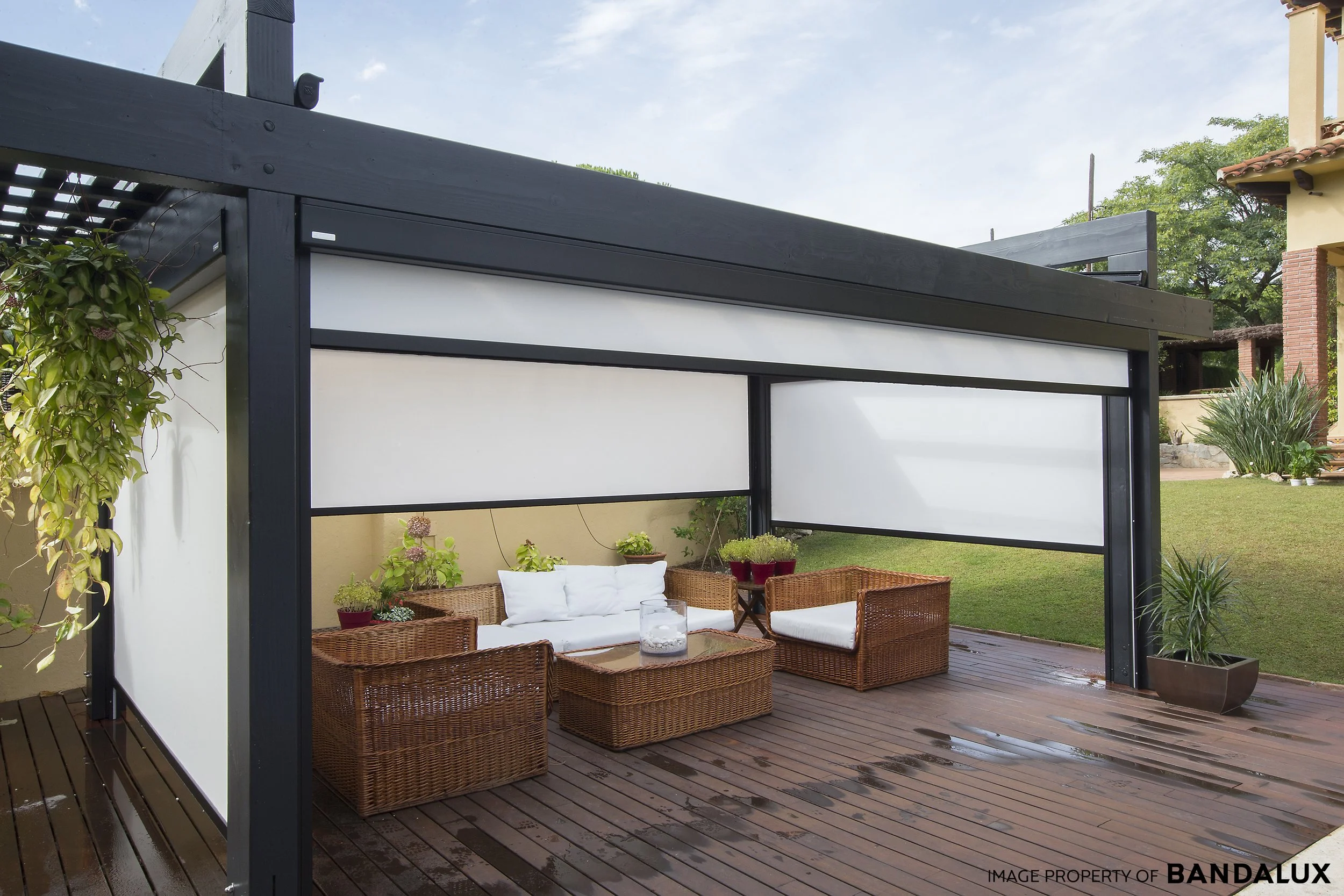 B box roller blind system installed outside in a beautiful garden.