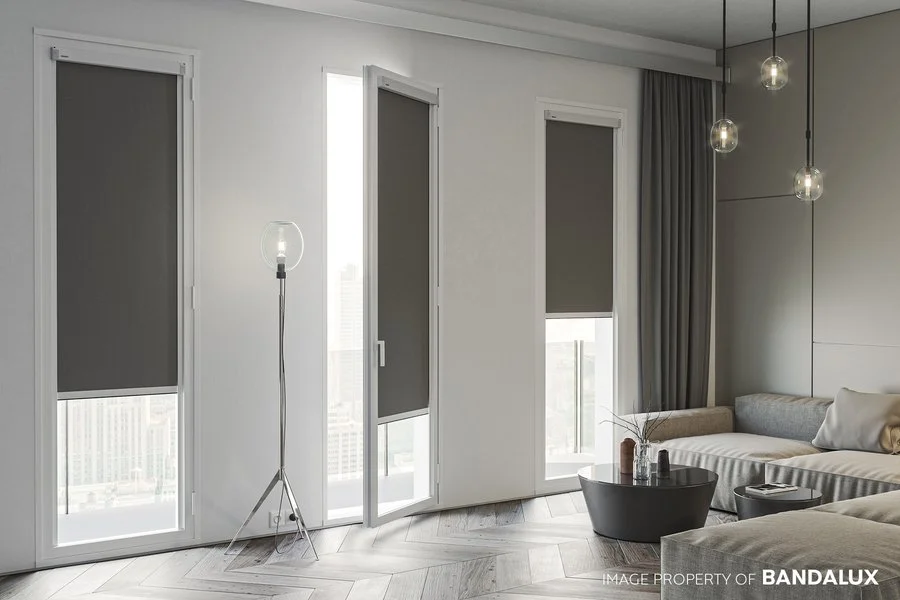 Custom fit roller blinds with grey fabric in a modern living room.
