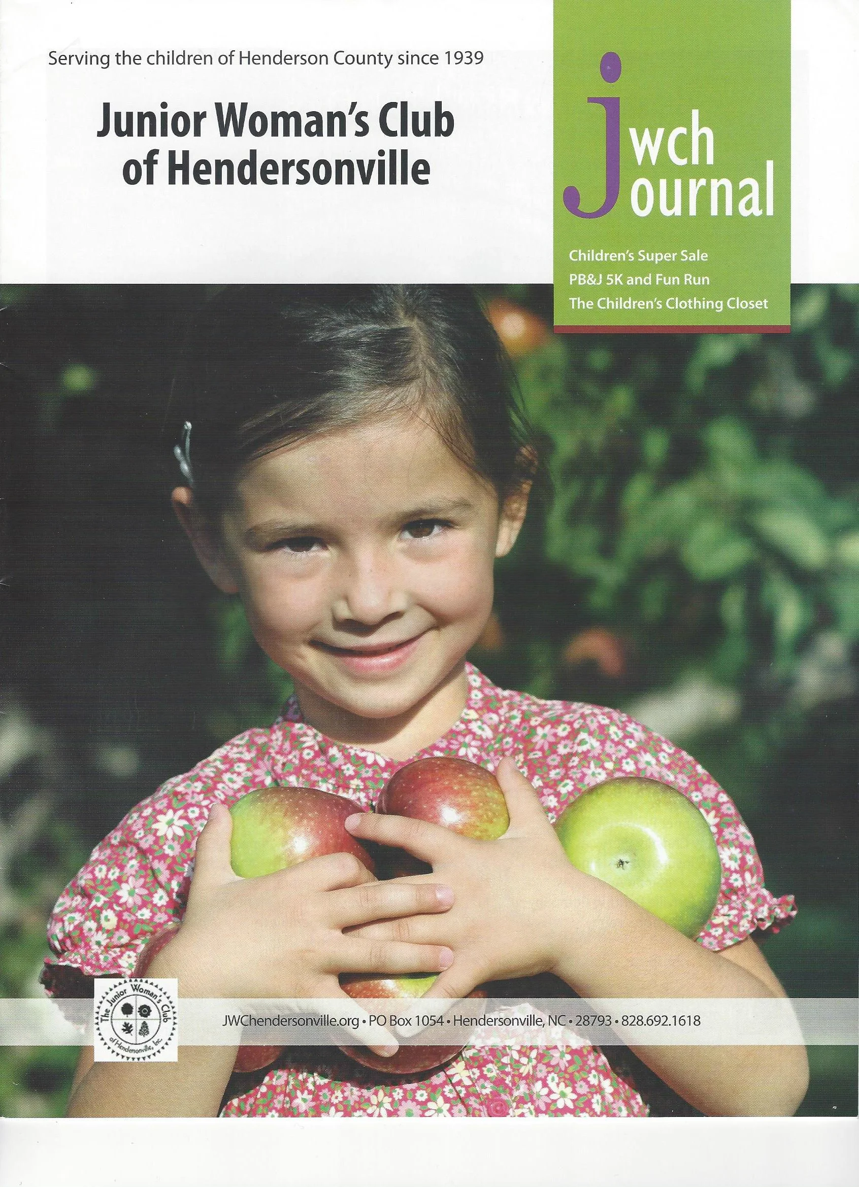 A young girl smiling and holding three apples, two red and one green, outdoors with greenery in the background. The cover is for the Junior Woman's Club of Hendersonville newsletter.