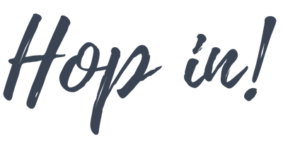 The image displays the phrase 'Hop in!' written in a playful, cursive font.