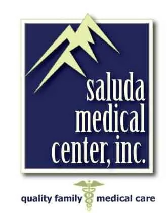 Logo for Saluda Medical Center Inc. with mountain design and medical caduceus symbol.