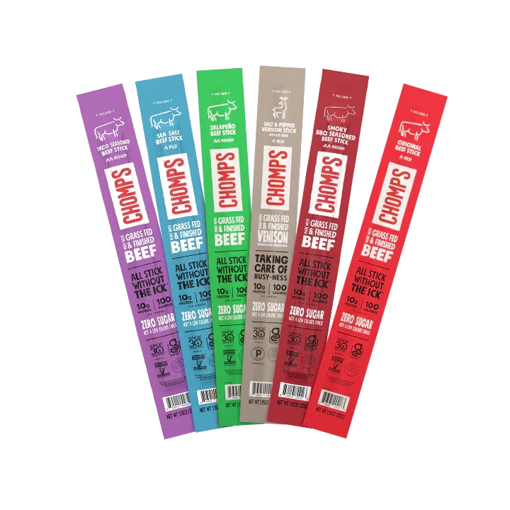 Five packages of Chomps grass-fed beef sticks in purple, blue, green, beige, and red packaging.