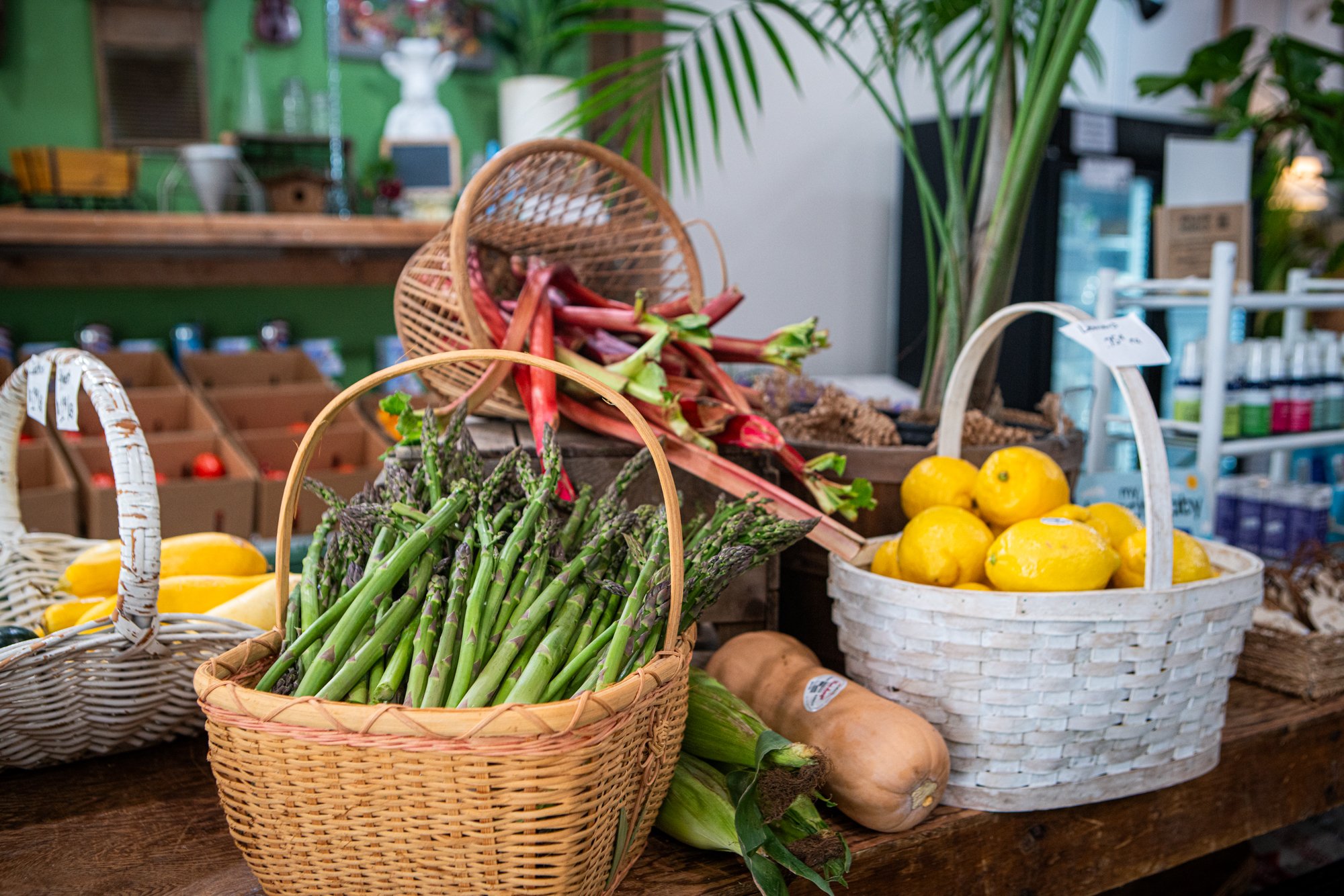 Assorted fruits and vegetables in baskets on a rustic wooden table