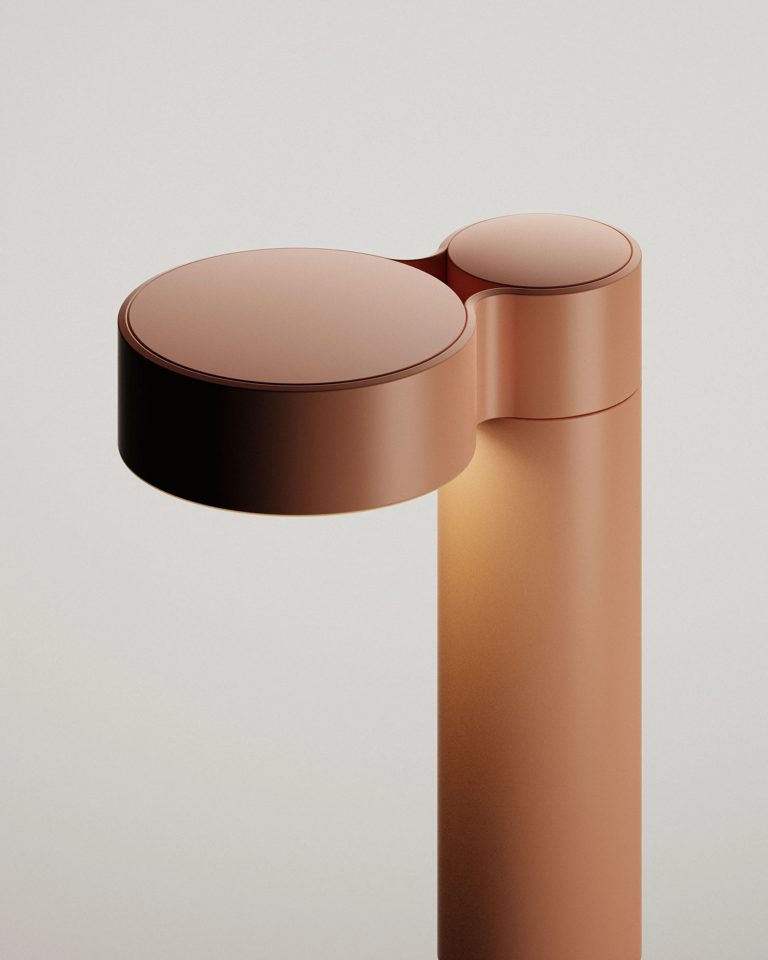 Close-up of modern terracotta table lamp designed by London industrial design agency for contemporary lighting solutions.