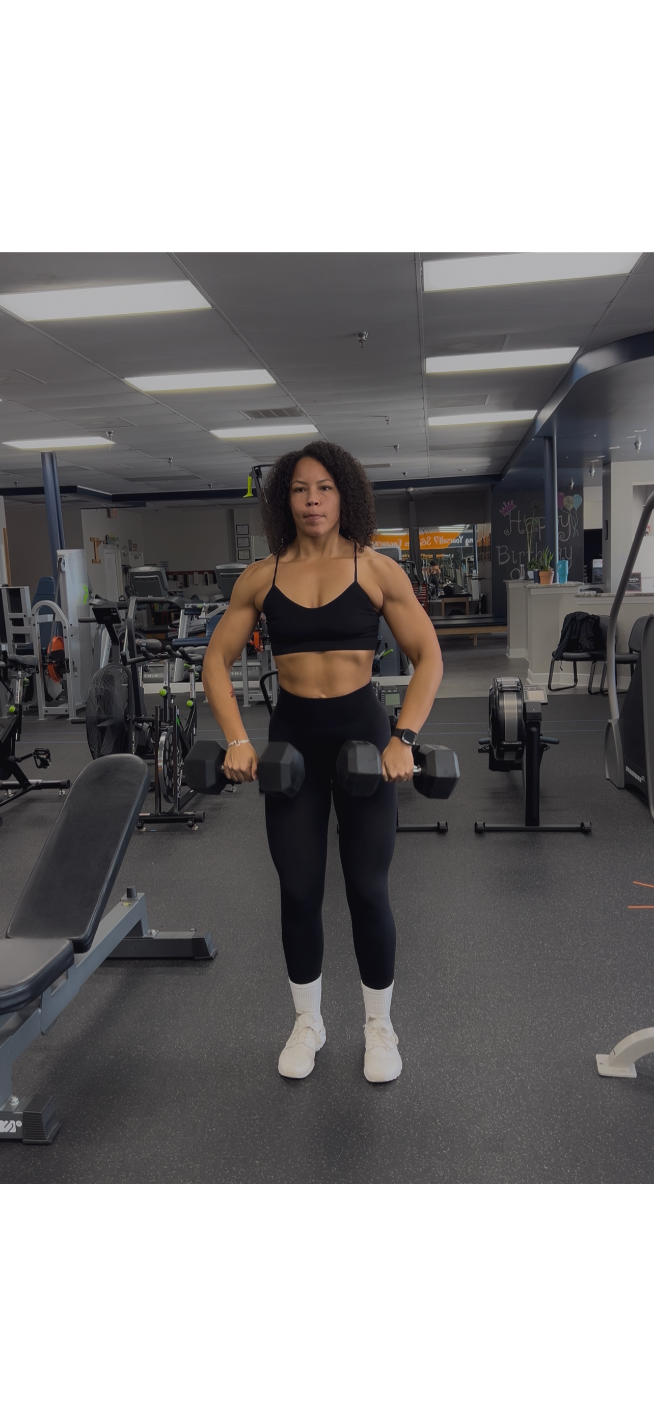 Mom lifting weights in a gym — representing the Elite Evolution coaching program for busy moms seeking strength, confidence, and sustainable fitness results