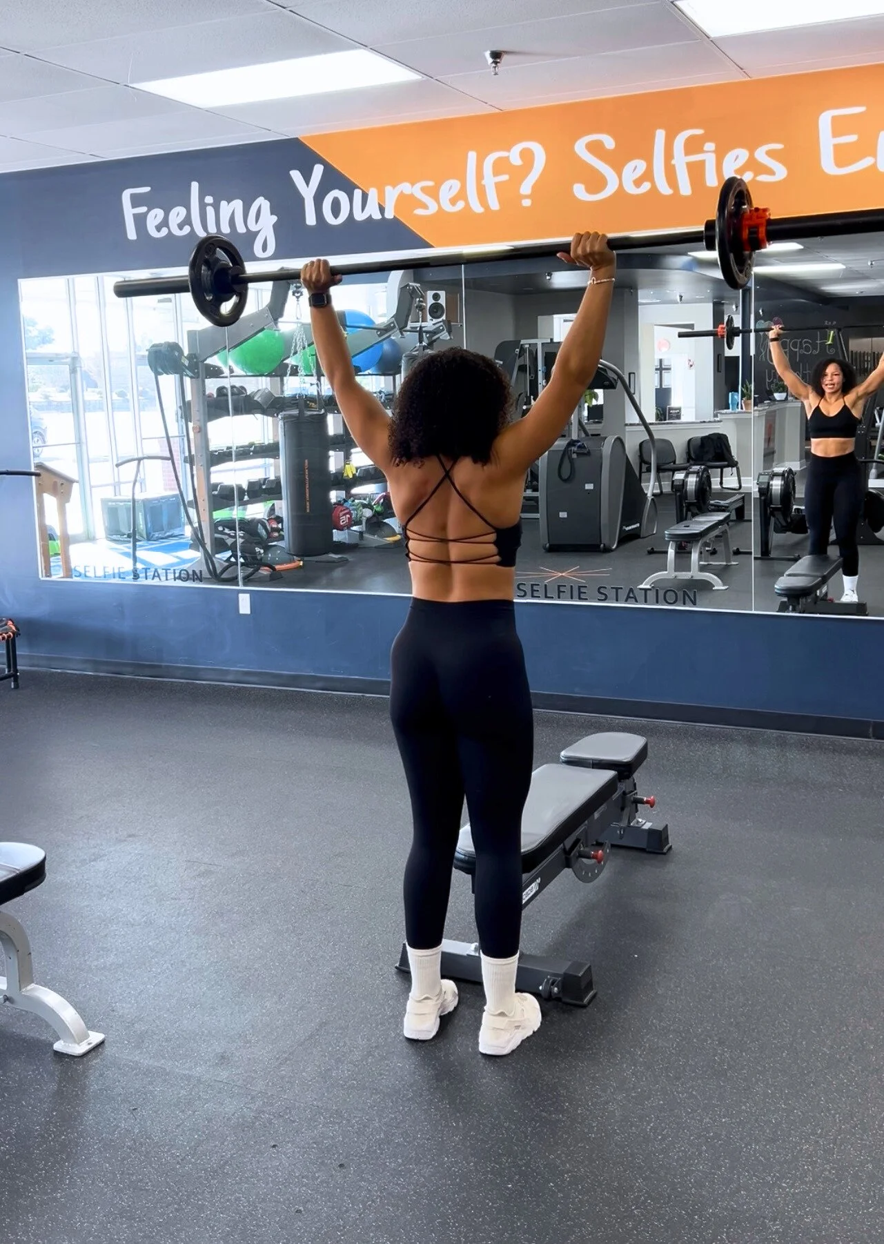 Woman lifting weights in the gym, representing the Alpha Mom Evo commitment to strength, evolution, and reclaiming your power.