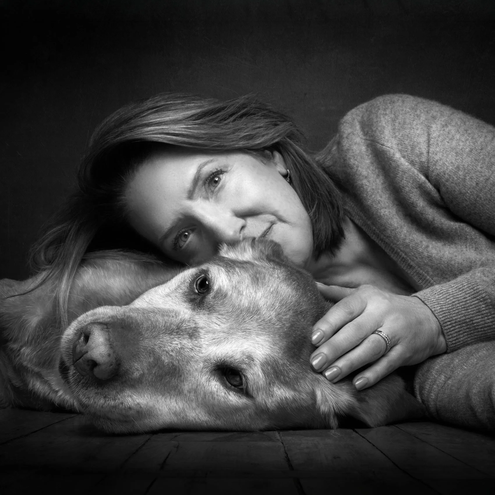 BW studio photo of a woman and her dog.