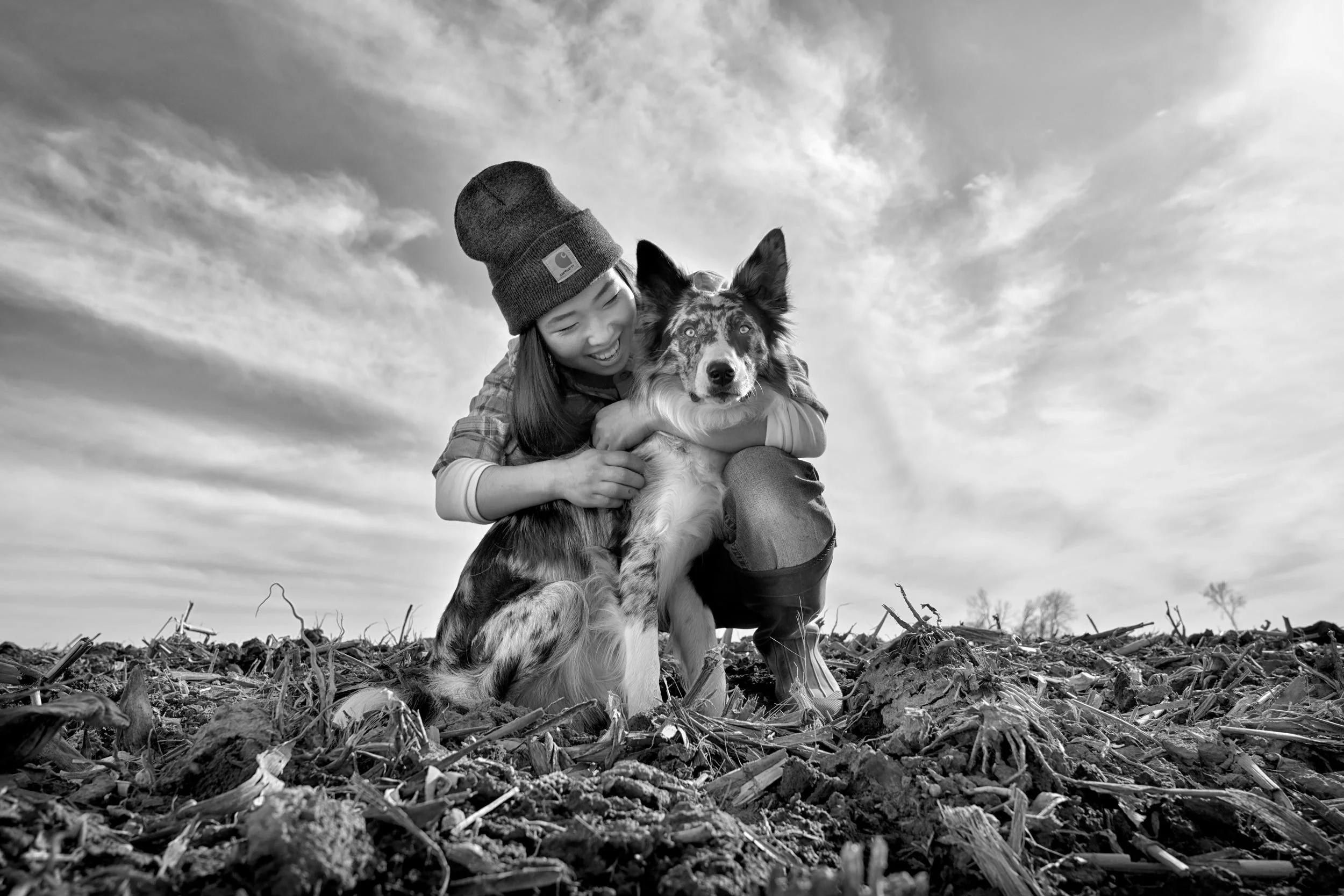 B&W location photo of a woman and her dog.