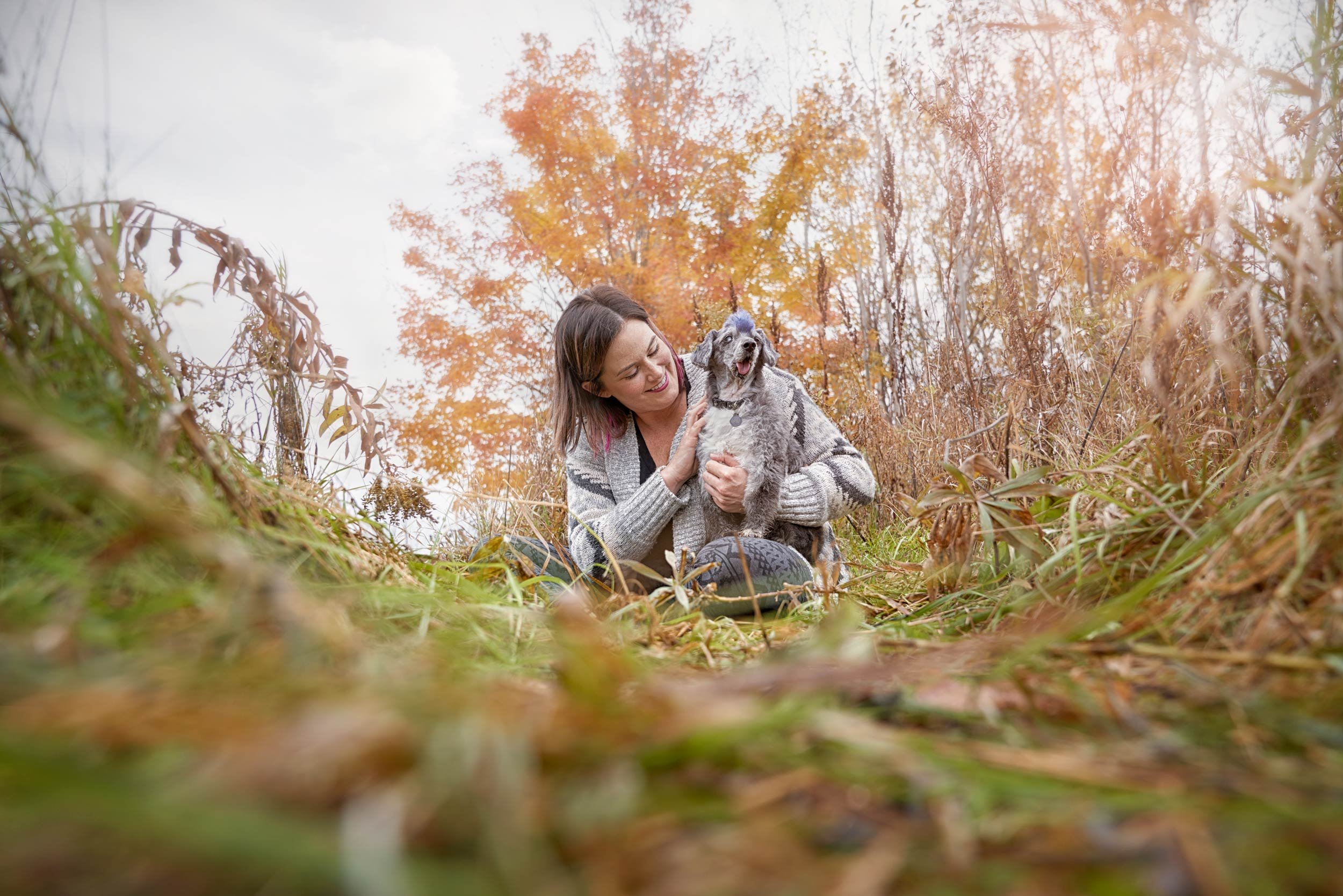 Portrait of a women with her senior dog.