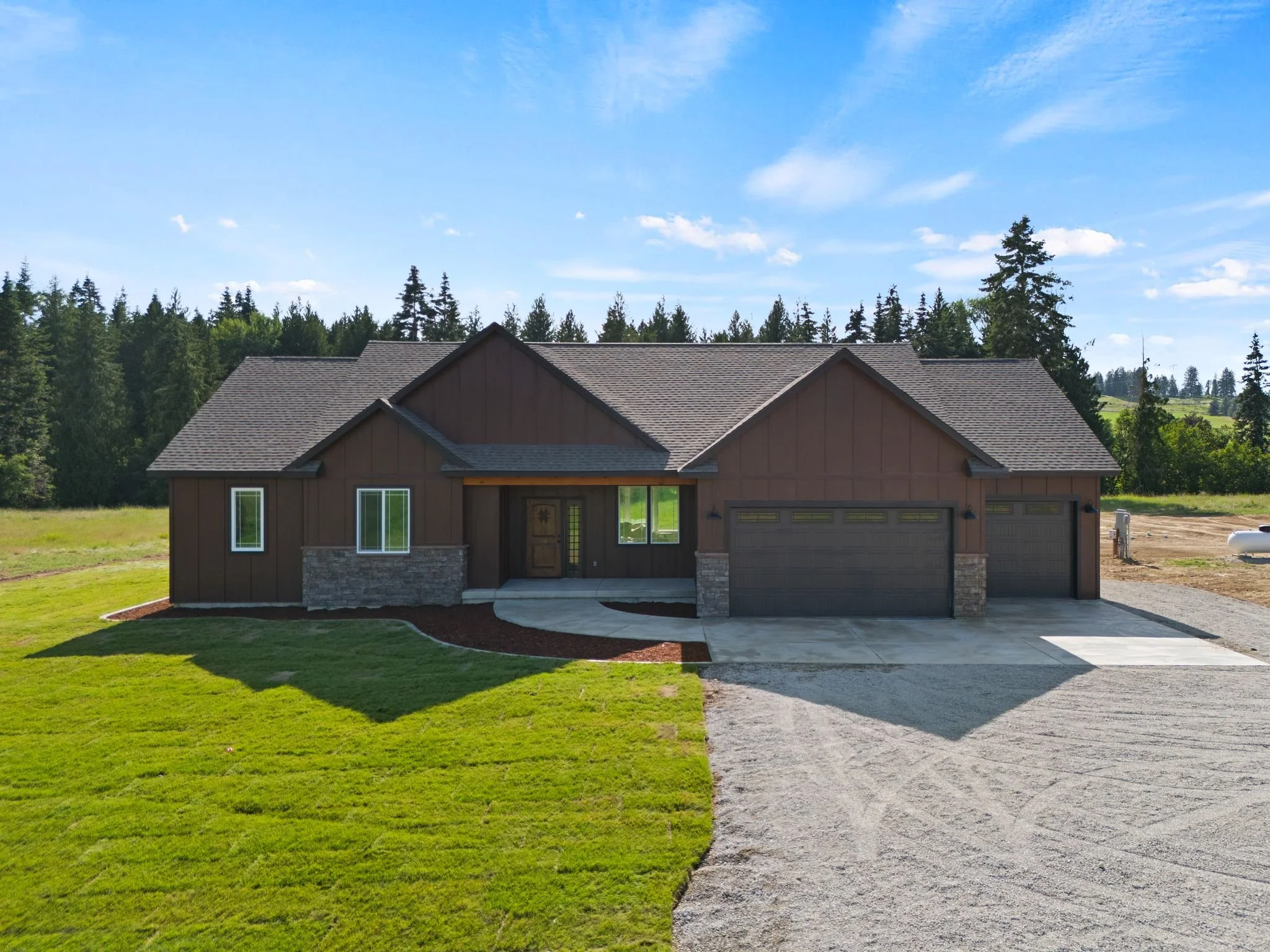 Large brown house in green field