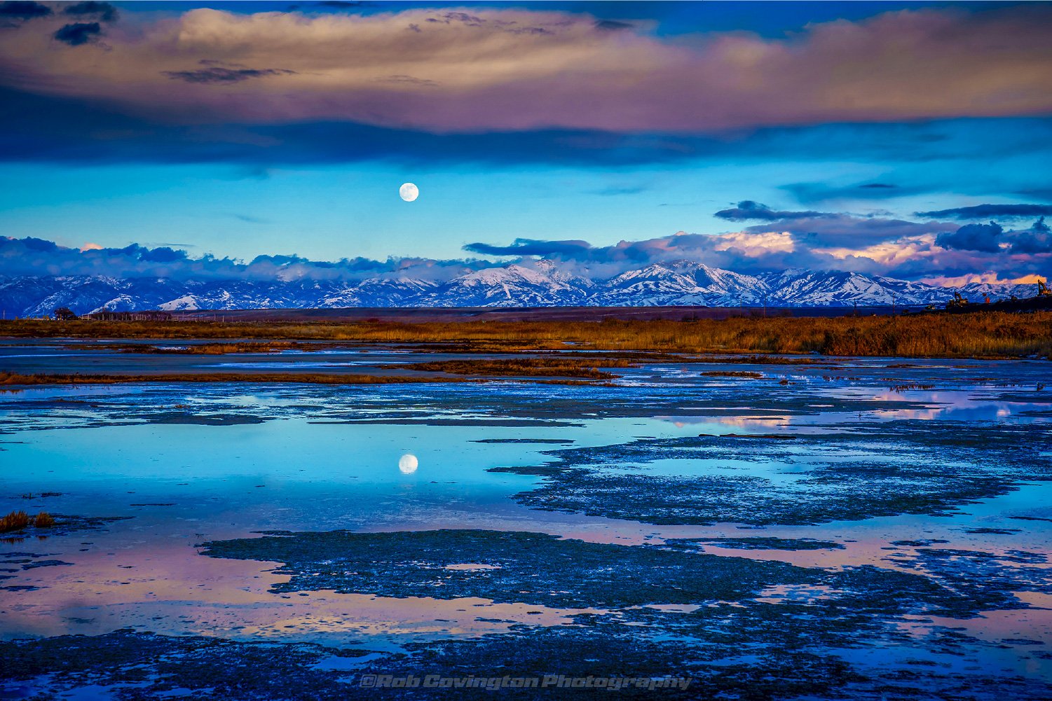 Landscape photography of the moonrise over the Wasatch mountains, reflecting in the Great Salt Lake, by Rob Covington.