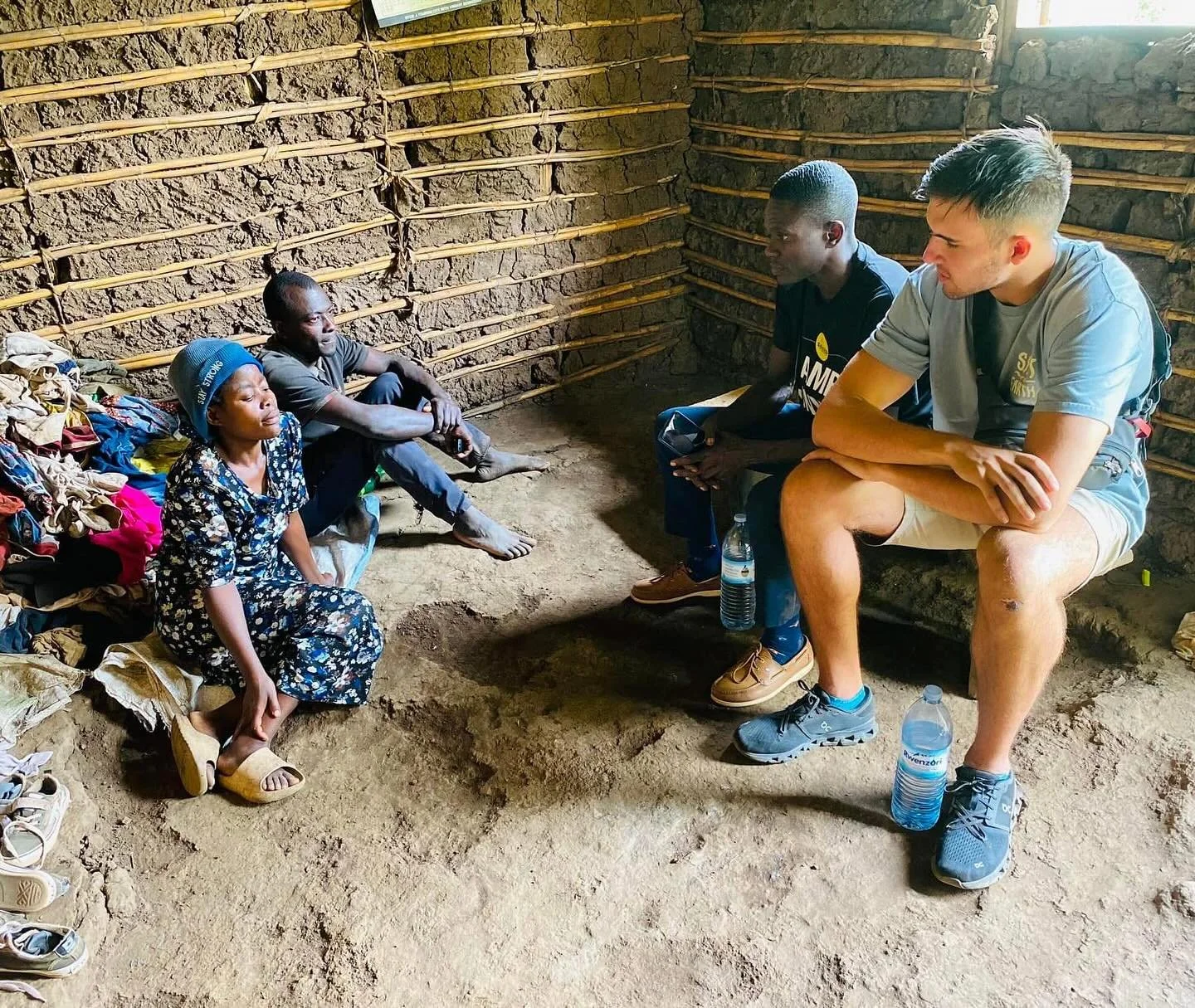 Luka and Moses visiting homes in the village. This is a very honouring gesture in African culture!
