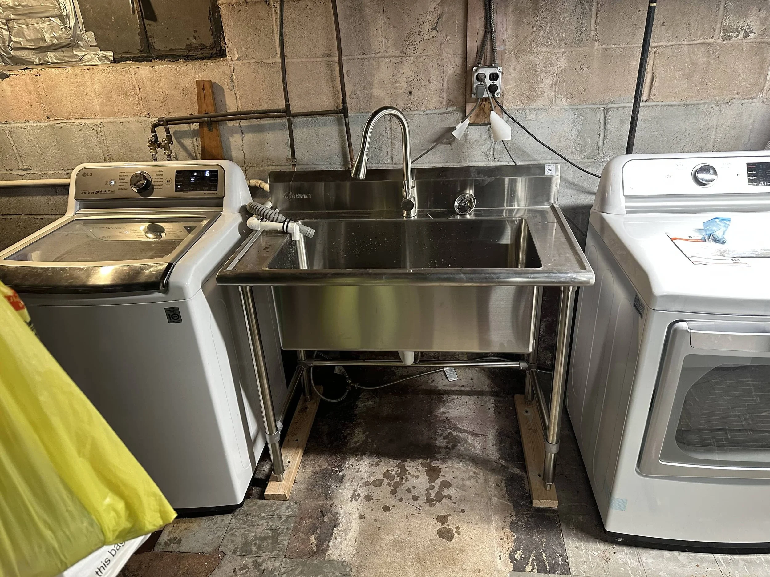 Laundry room with washer, dryer, and utility sink