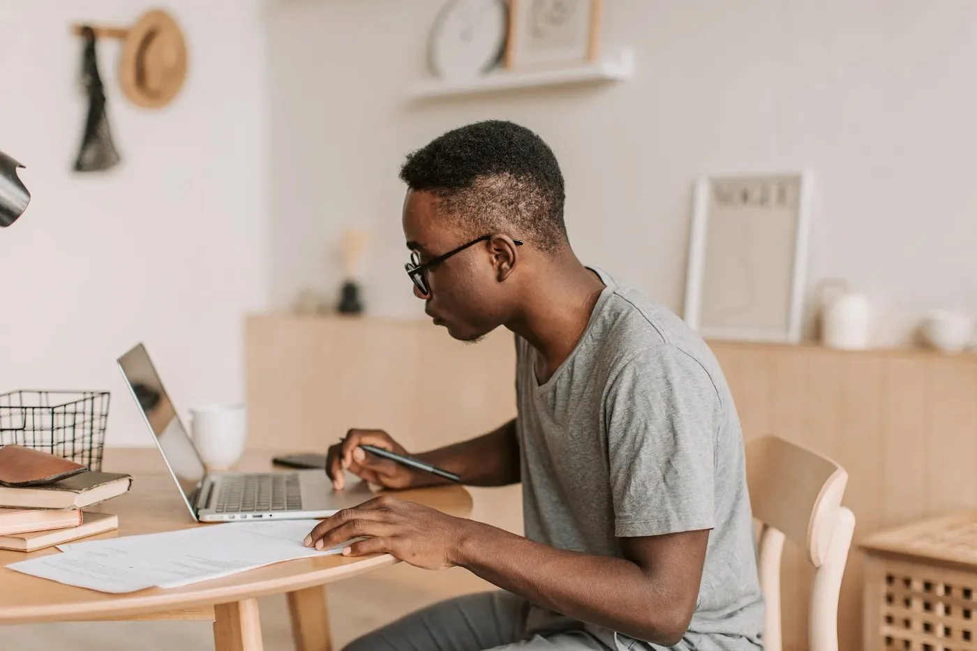 A man sits studiously at a desk making notes