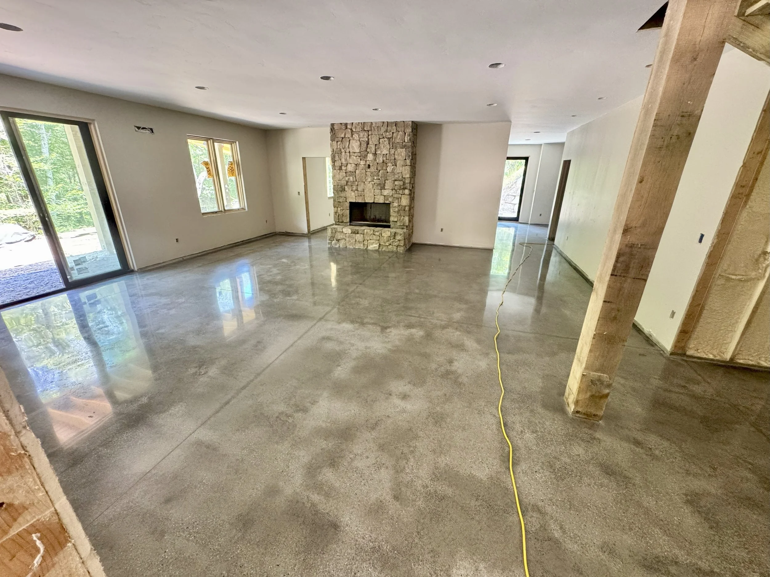 House under construction showing an acid washed stained and polished epoxy concrete floor in a basement