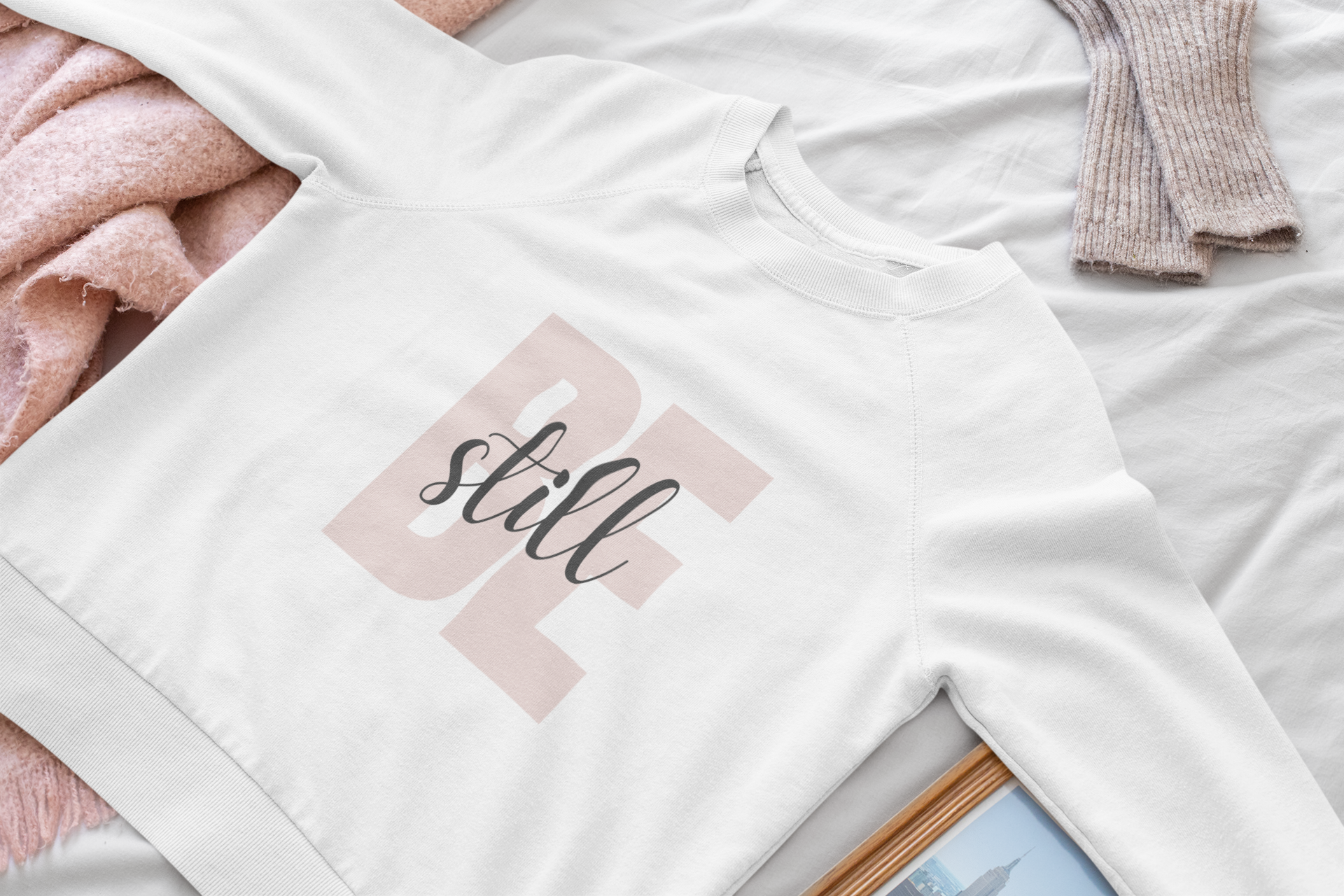 mockup-of-a-woman-s-crewneck-sweatshirt-lying-on-a-bed-33746 (1).png