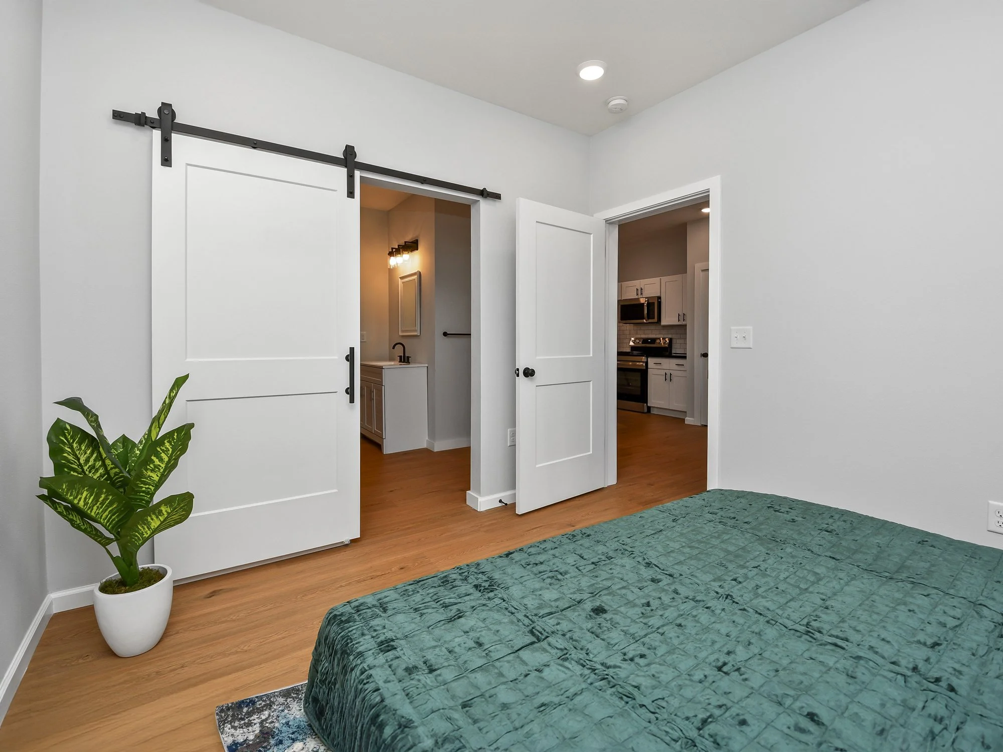 11-The-Knoll-1-Bed-bedroom-barn-door-bathroom.jpg