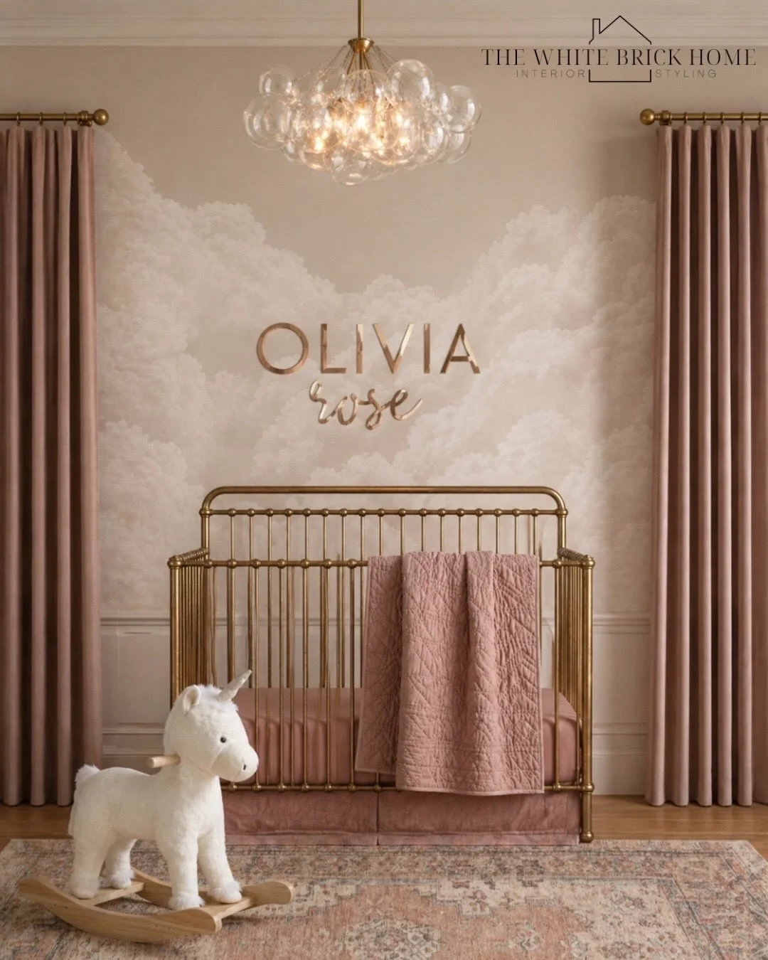 Soft blush tones, dreamy cloud wallpaper, warm brass accents, and the prettiest glow ✨☁️ This nursery was designed to feel timeless, feminine, and cozy with layered textures and soft neutral warmth throughout. 

Comment SHOP below to receive a DM wit