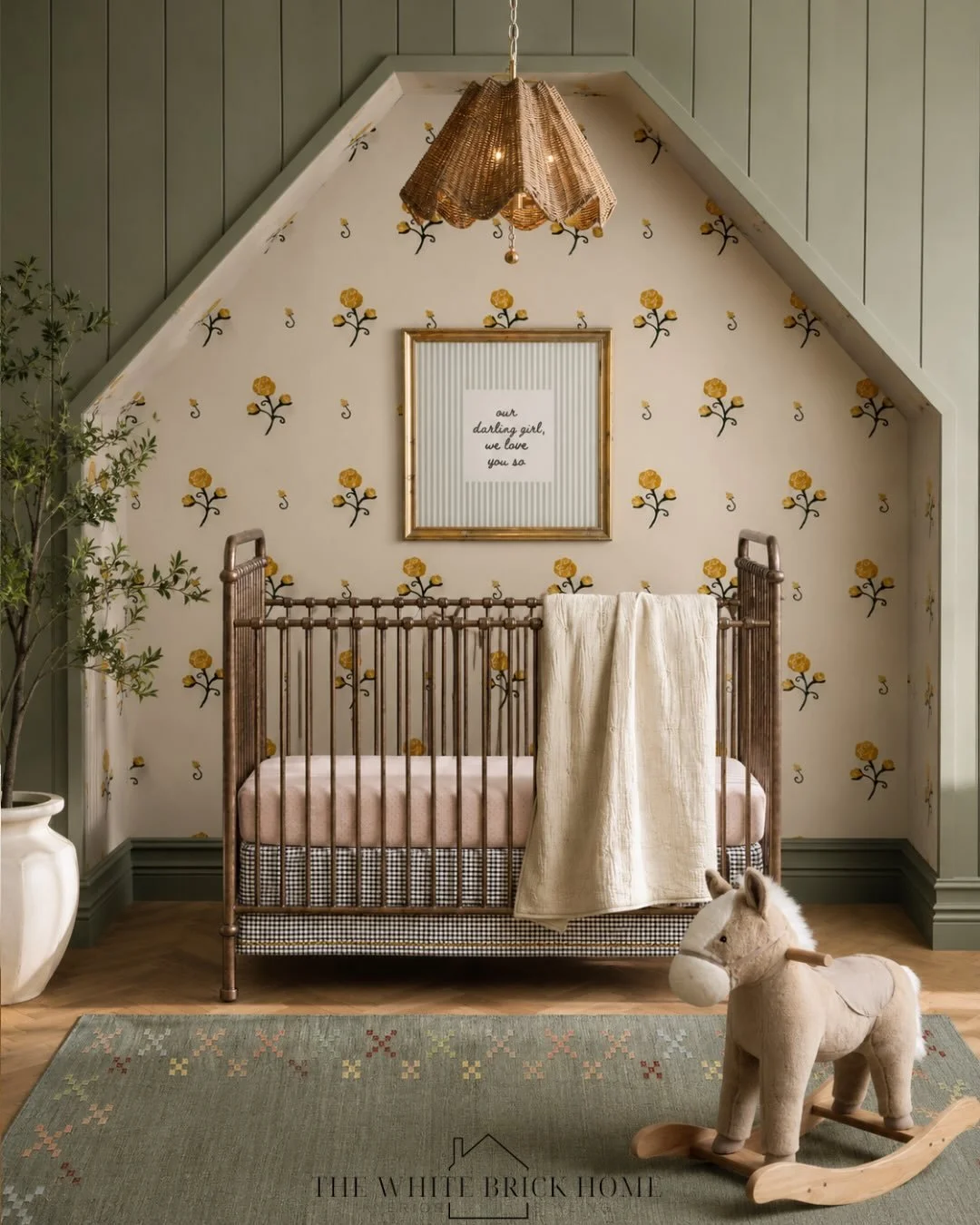 Golden blooms, warm olive tones, and vintage-inspired details come together to create a nursery that feels both timeless and whimsical. From the floral wallpaper and statement drapery to the heirloom-style crib and thoughtfully styled book ledges, ev