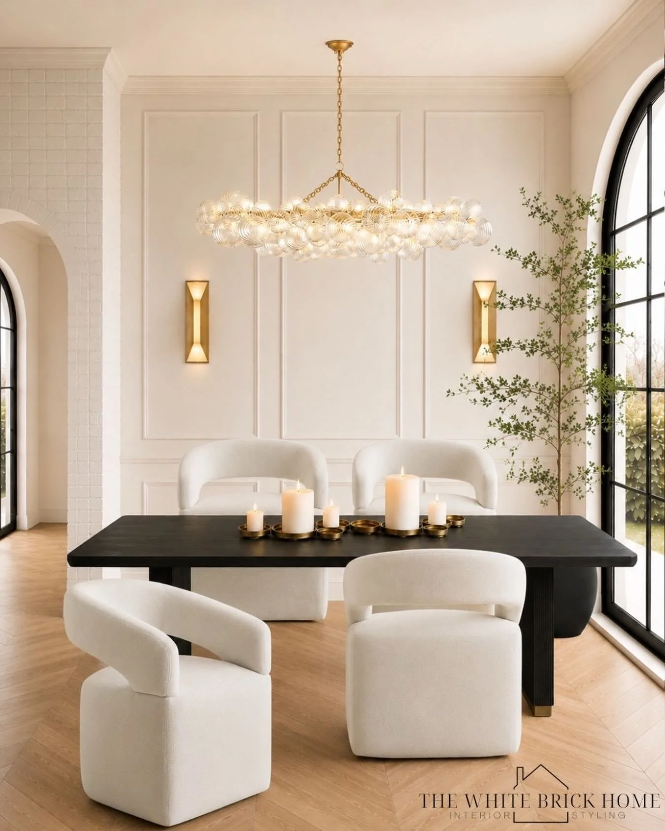 Soft curves, warm brass, and timeless details 🤍✨ This modern traditional dining room layers rich contrast and elegant textures for a look that feels both elevated and inviting. From the statement chandelier to the sculptural boucle chairs, every det
