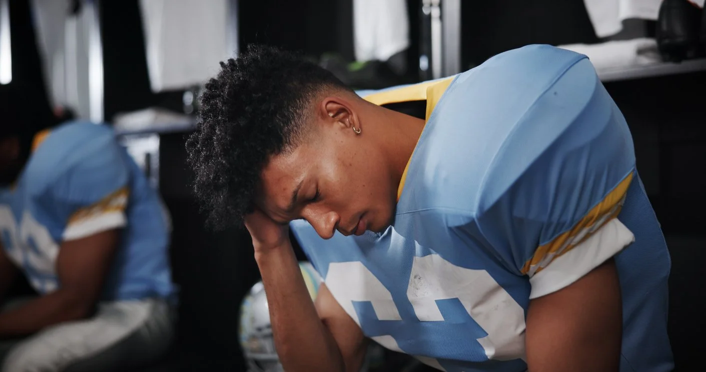 young football player suffering from a head injury