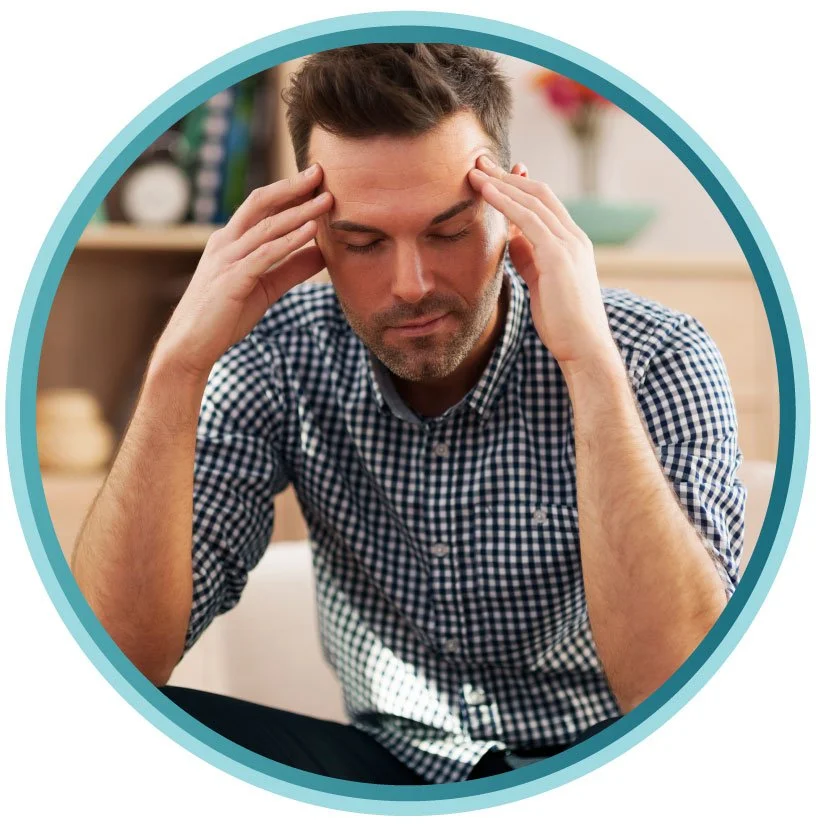 man holding head appearing stressed