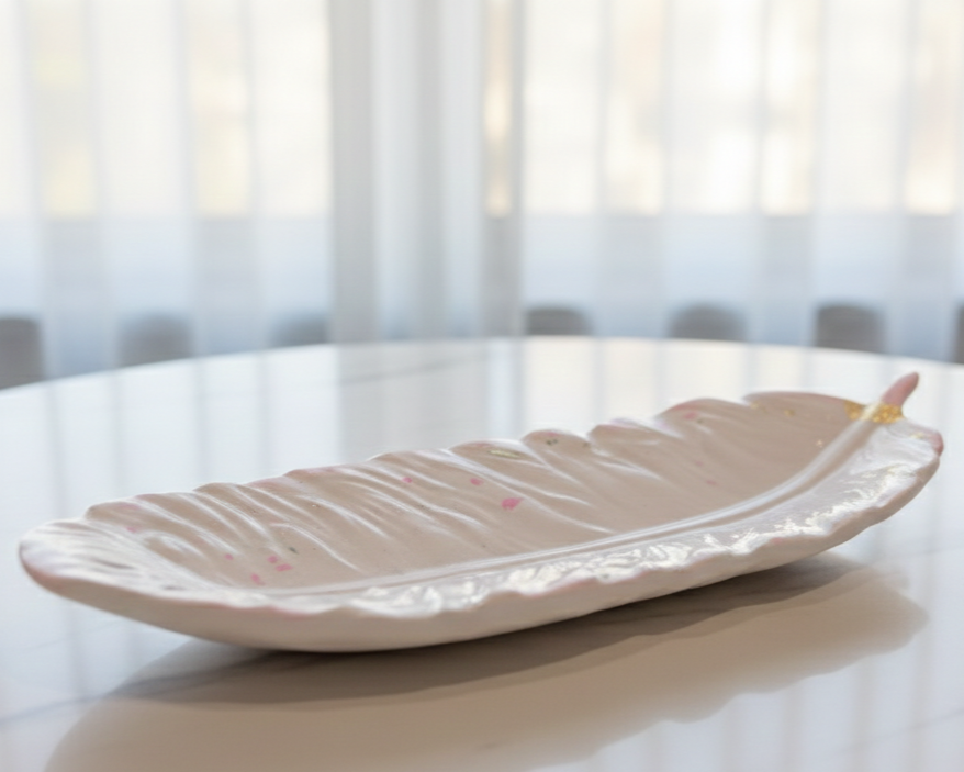 Person wearing white gloves holding a pink candle in a glass jar with a label that reads "Don't Burn Out" against a white background.