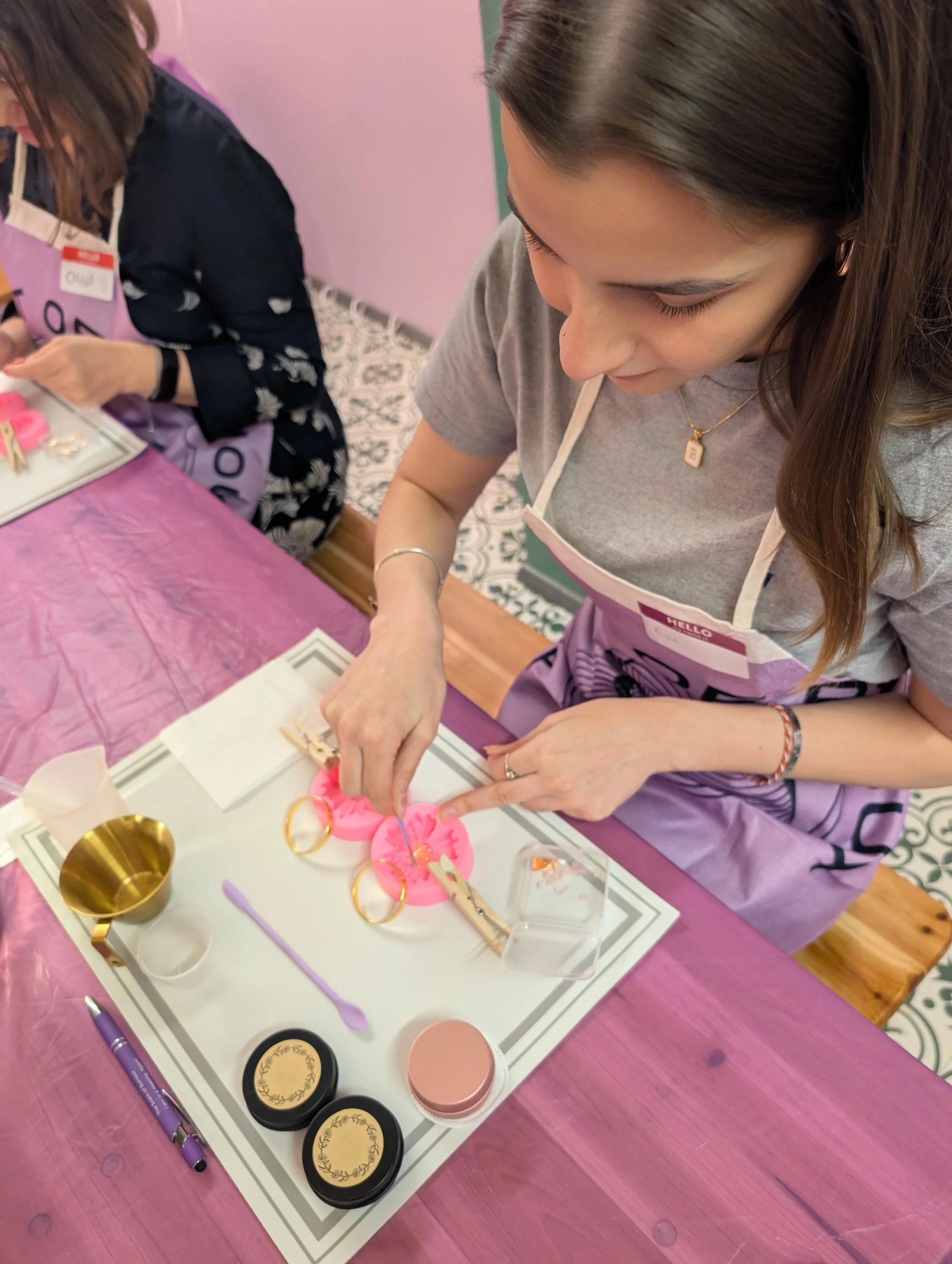 A corporate team building participant at a workspace table carefully crafting with eco-stone materials, molds, and premium tools in London during a corporate wellness activity hosted by The Scent of Burnout.