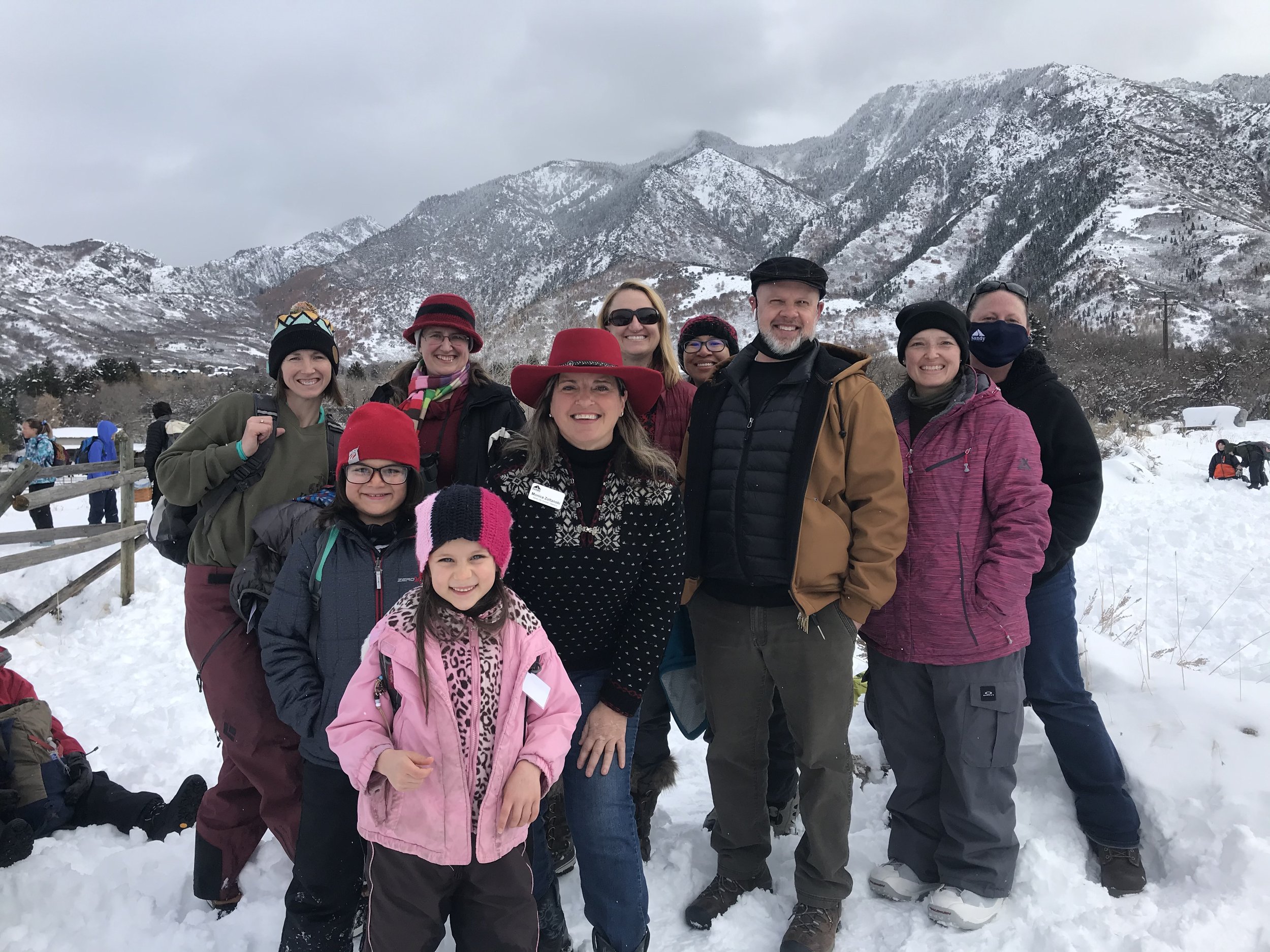 “A group of dedicated volunteers stands together at Dimple Dell, Utah, ready to make a difference. Their efforts, supported by Monica Z’s leadership, focus on improving local parks.