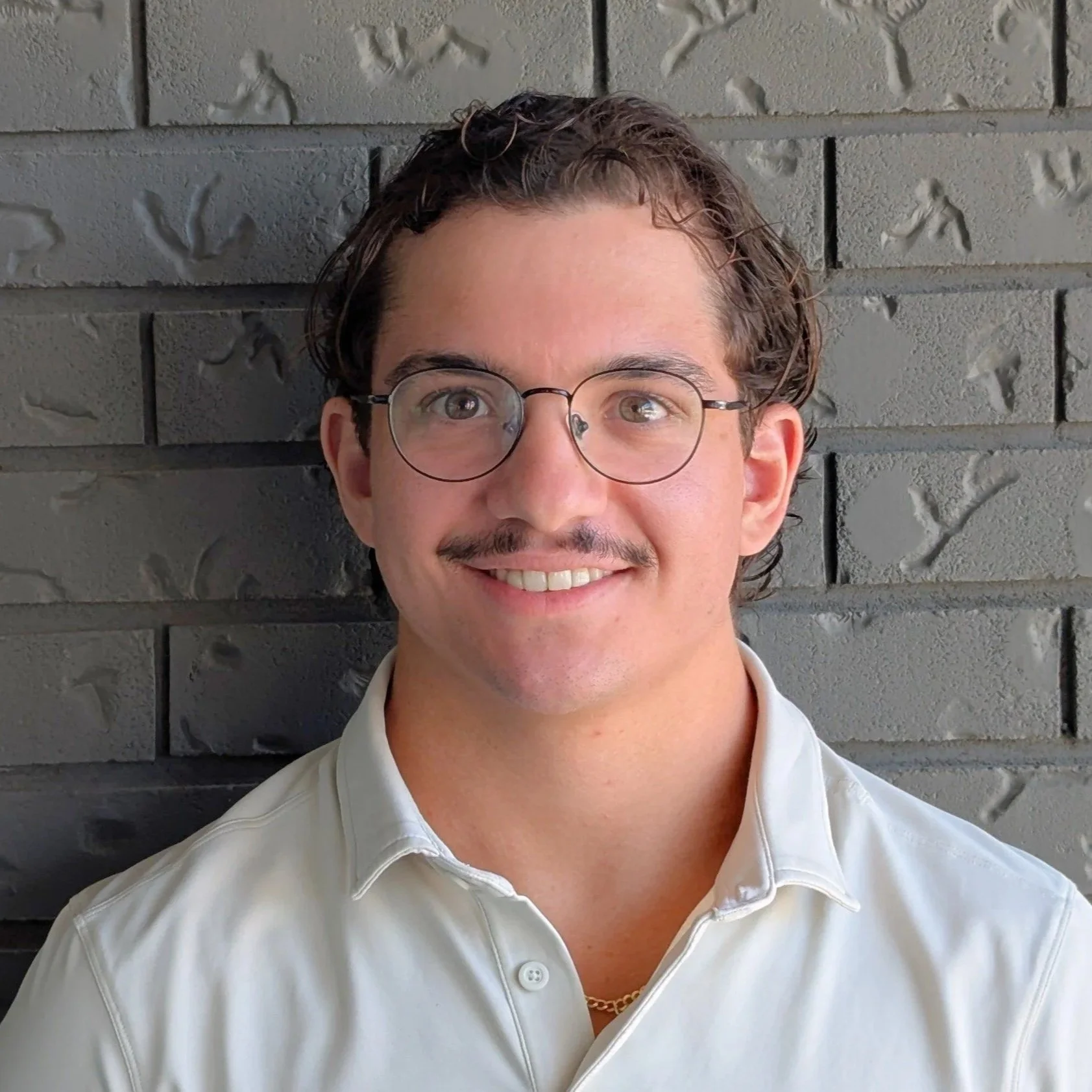 Young man with glasses smiling 