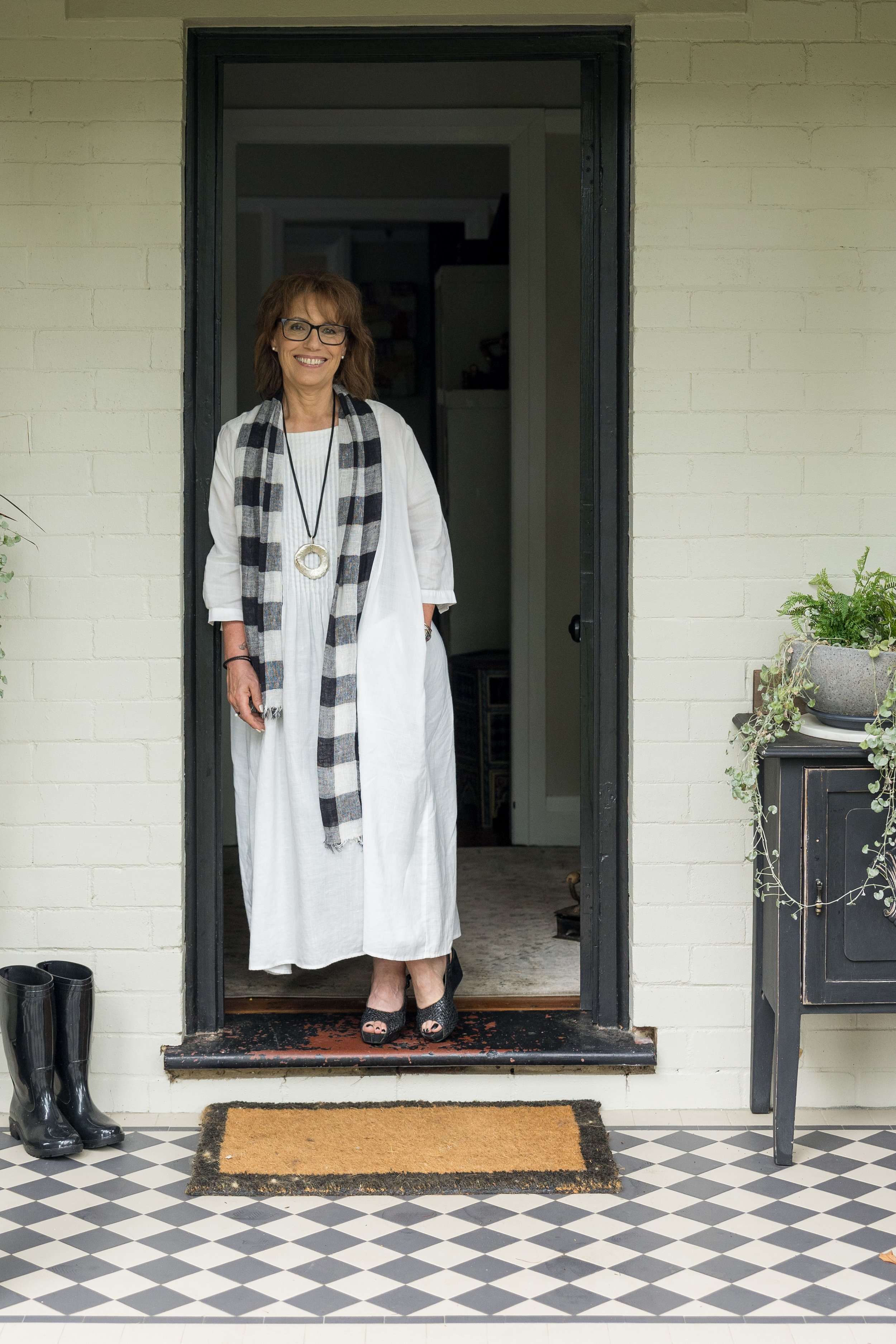 Morag Everdene standing against door, therapist life coach