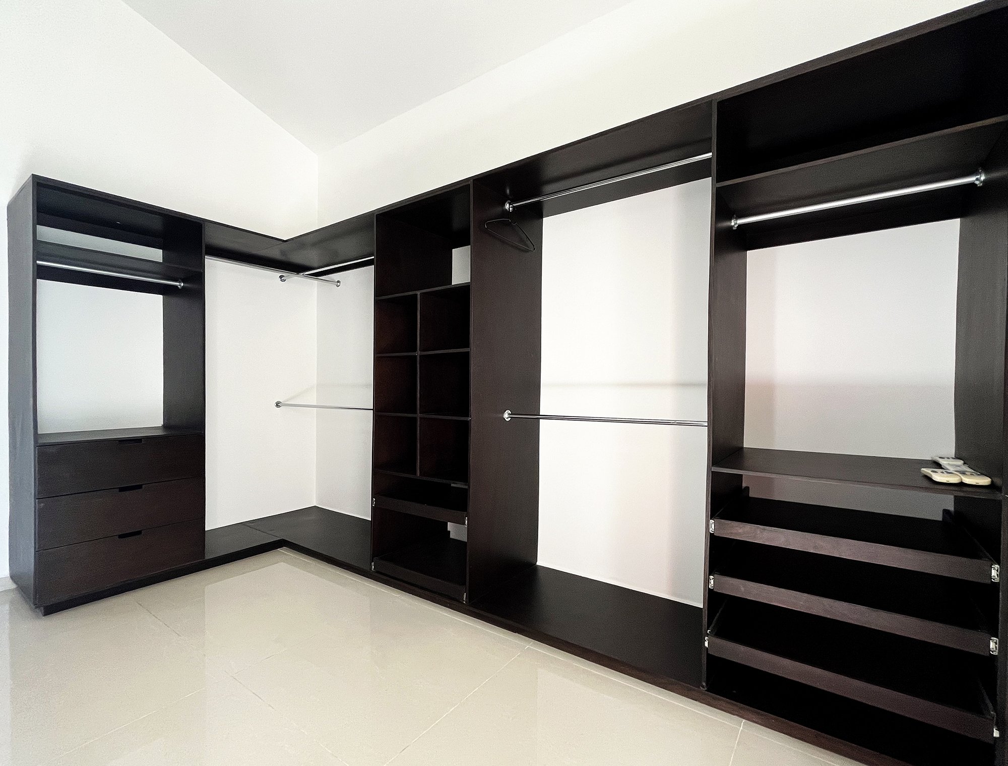 Empty wooden closet with shelves and hanging rods