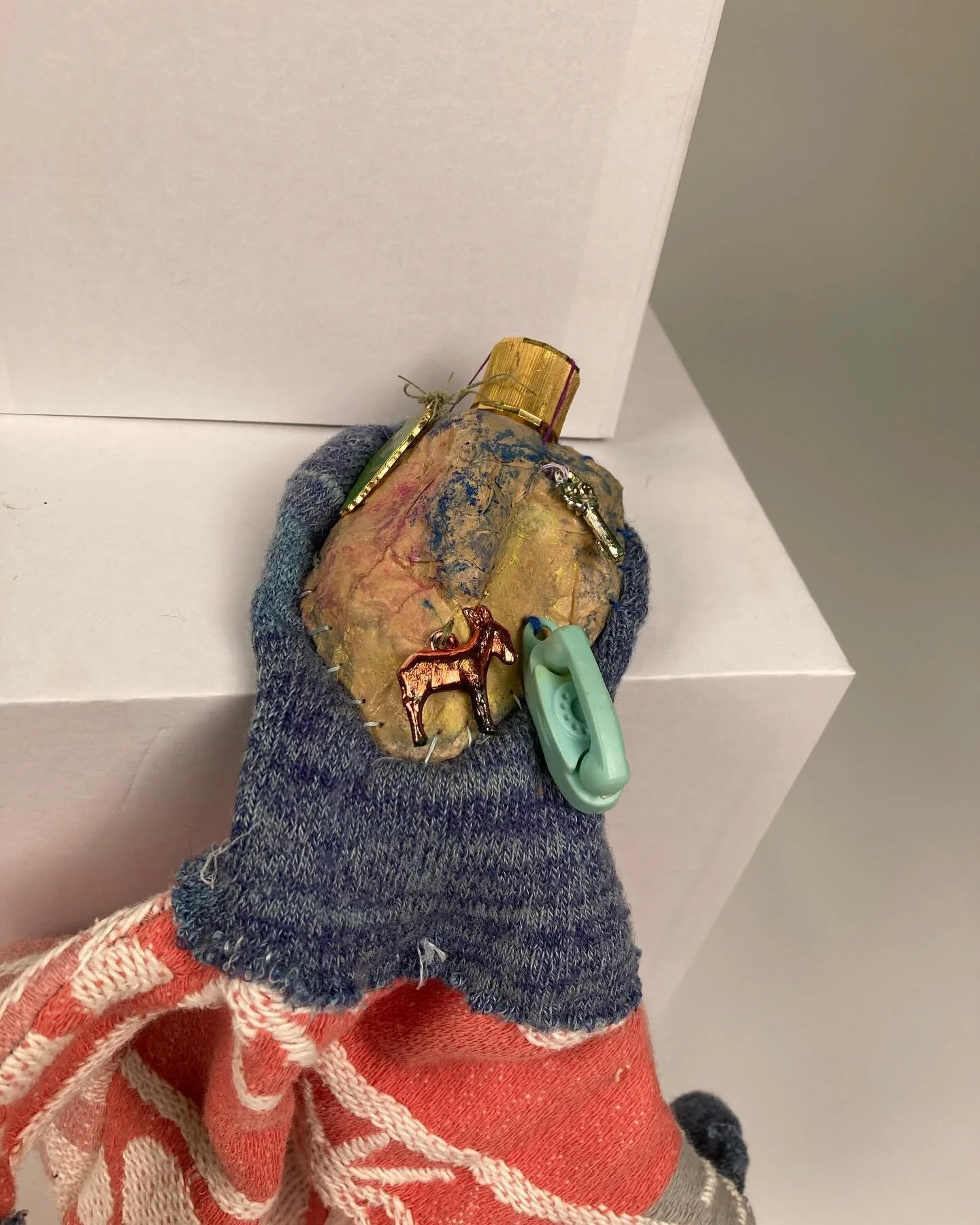 The Preacher, 2024.
Hand puppet made from an old sock, vintage comforter, brown bag papier-m&acirc;ch&eacute;, oil pastels, vintage charms and sticky wax.
#puppet #handpuppet #makemcad #fiberarts