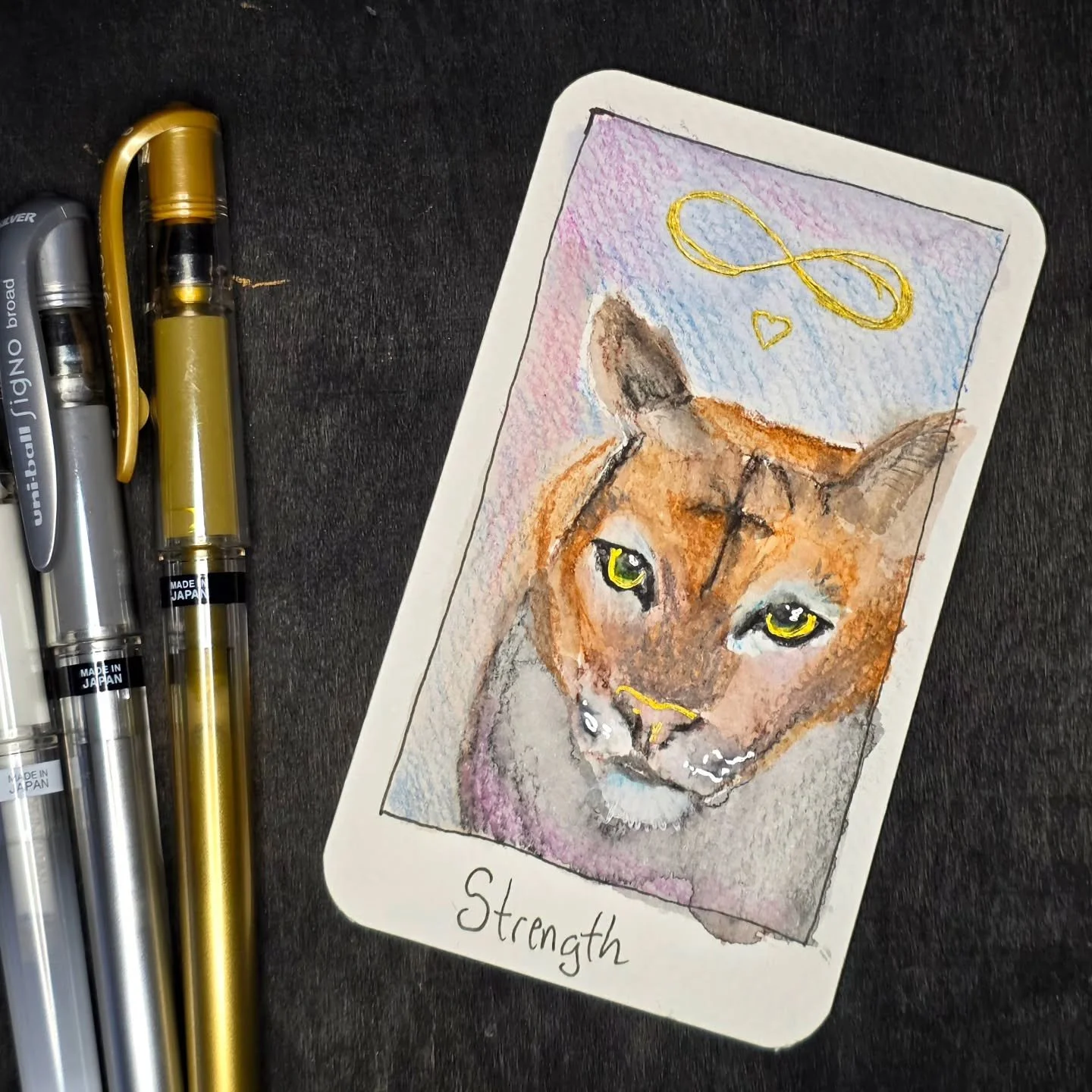 Day 4's tarot card is the Strength card. A card about having internal strength without loosing the gentle side, a quiet confidence that can't be shaken. Usually depicted as a woman and lion, but the cougar has come up in dreams and readings so she is