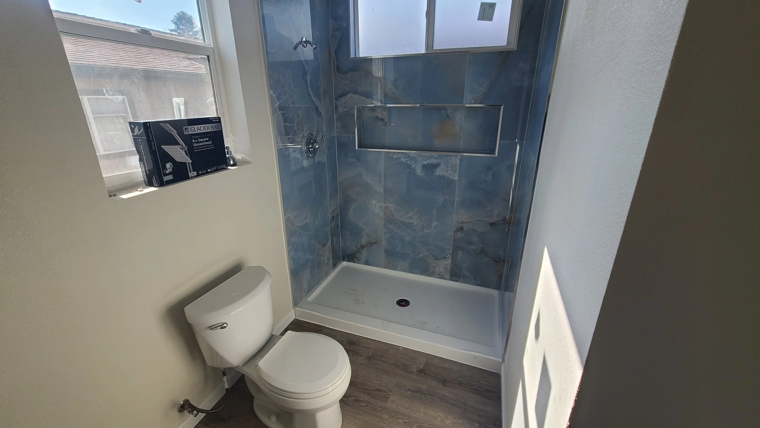 ADU bathroom with full shower tile with custom color mix grout