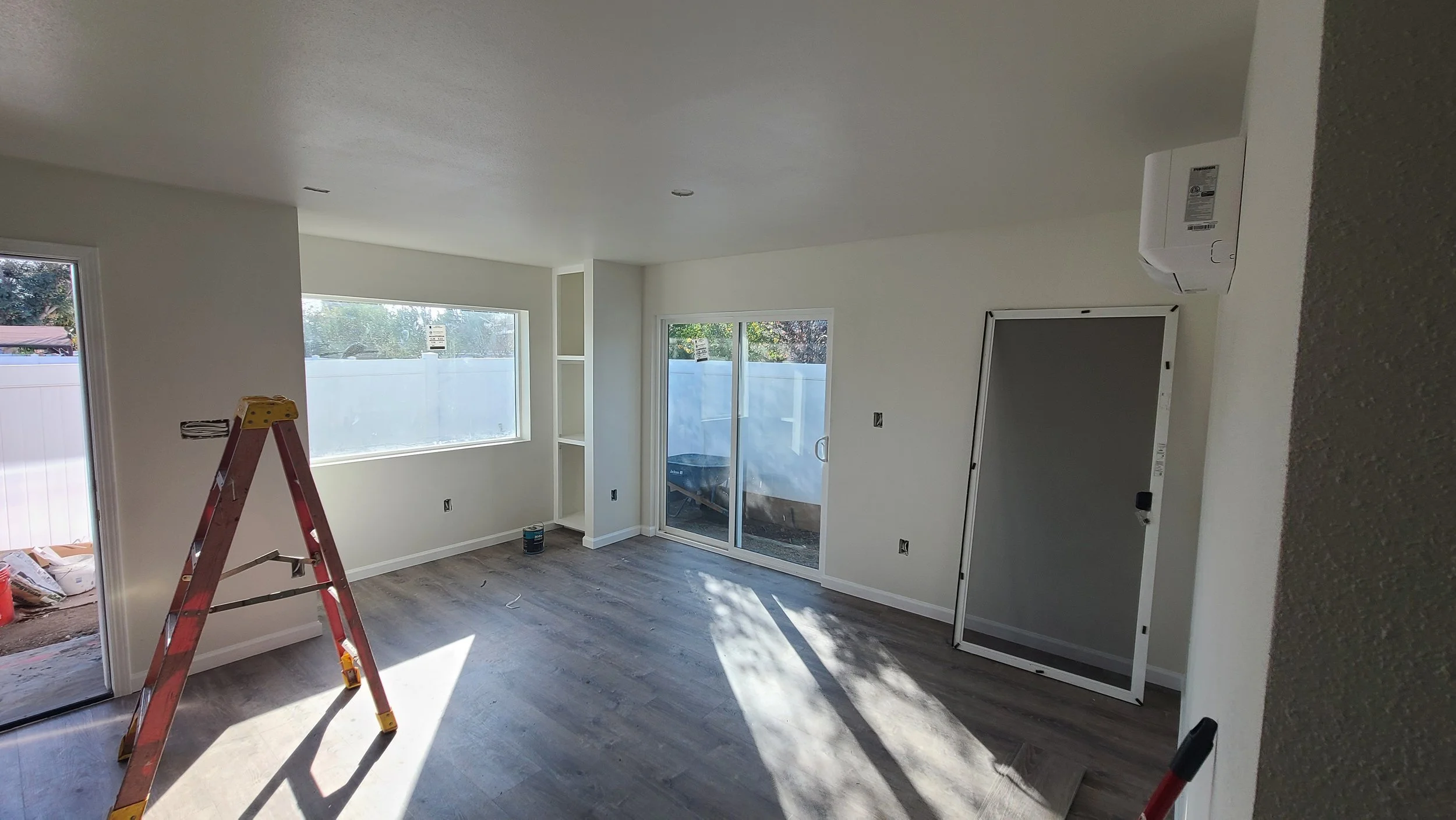 ADU kitchen and living room with an open floor concept, with linen shelves for extra storage