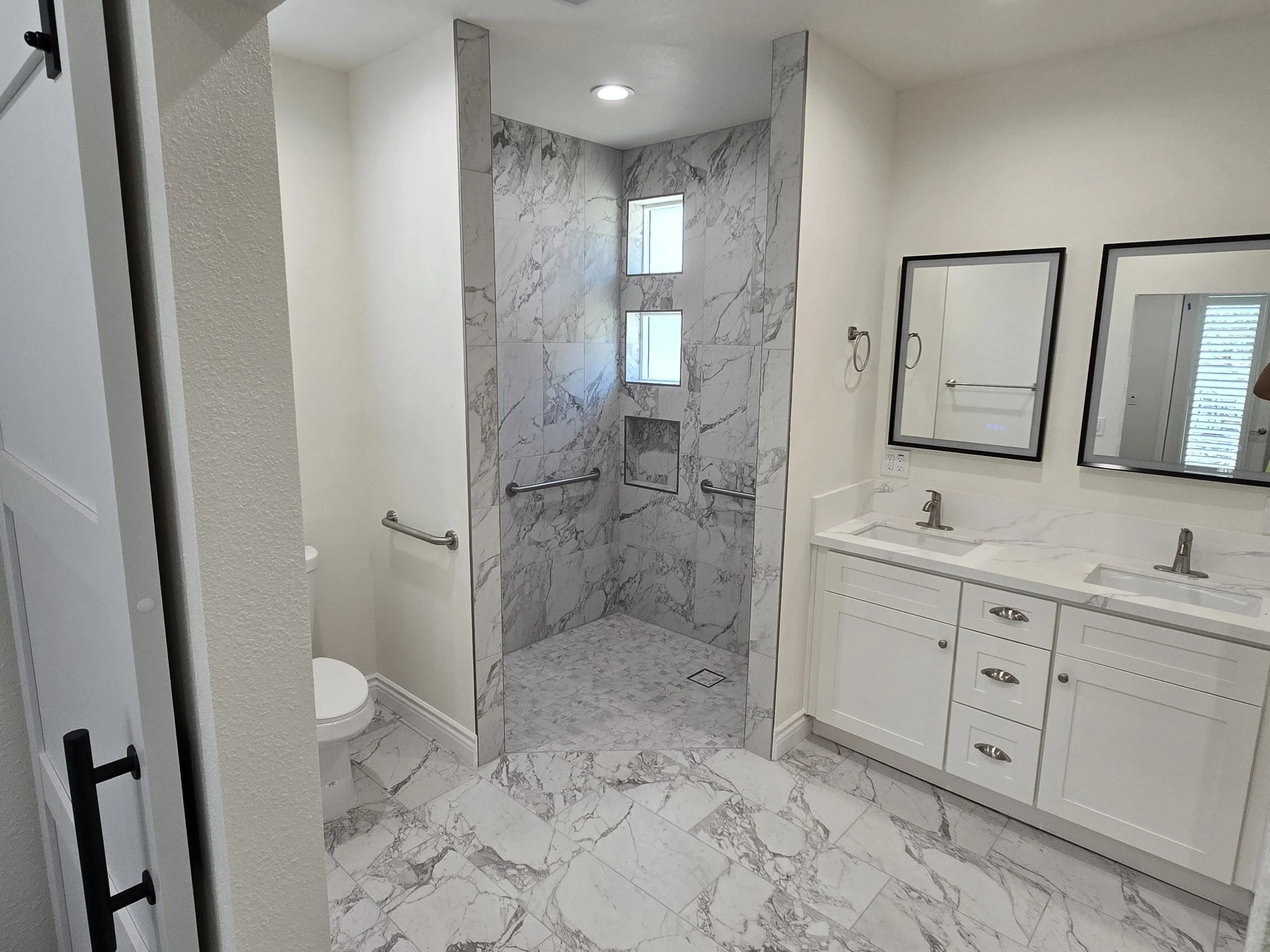 Large ADU Master Bathroom with porcelain tile floors, shower porcelain tiles, upgraded heated floor with a vanity with quartz countertop