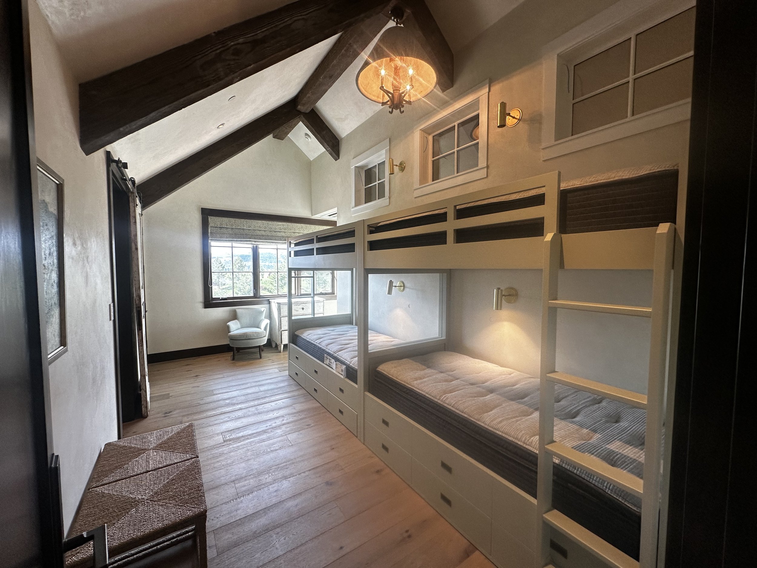 What was once an underutilized room was completely transformed by Smith Works into a warm and welcoming grandkid retreat. This thoughtful addition maximized space with custom built-in bunk beds, durable yet refined finishes, and clever storage solut