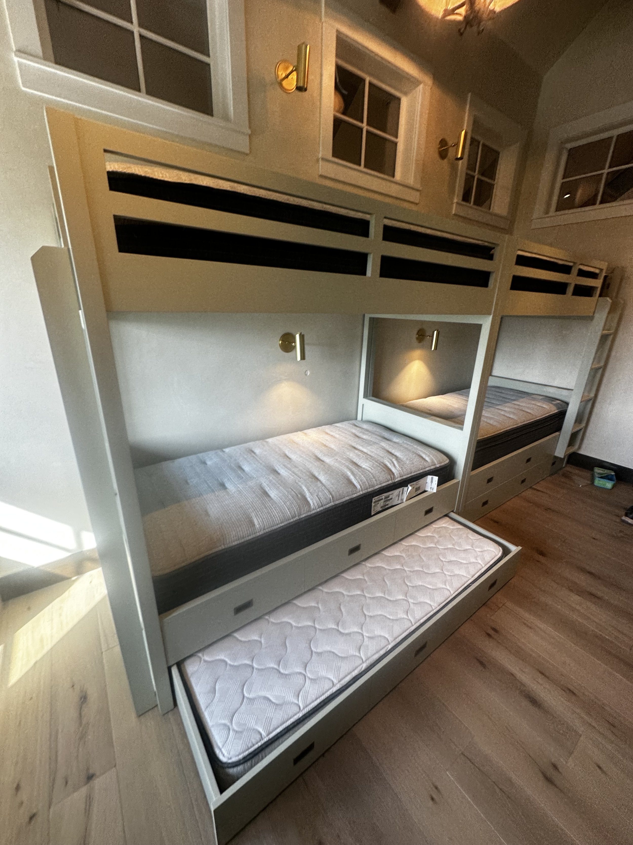 What was once an underutilized room was completely transformed by Smith Works into a warm and welcoming grandkid retreat. This thoughtful addition maximized space with custom built-in bunk beds, durable yet refined finishes, and clever storage solut