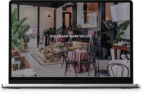 Screenshot of a website for Silverado Napa Valley showing a stylish indoor lounge with plants, a pink tablecloth-covered table, and black chairs. San Francisco Bay Area corporate event and headshot photographers and videographers