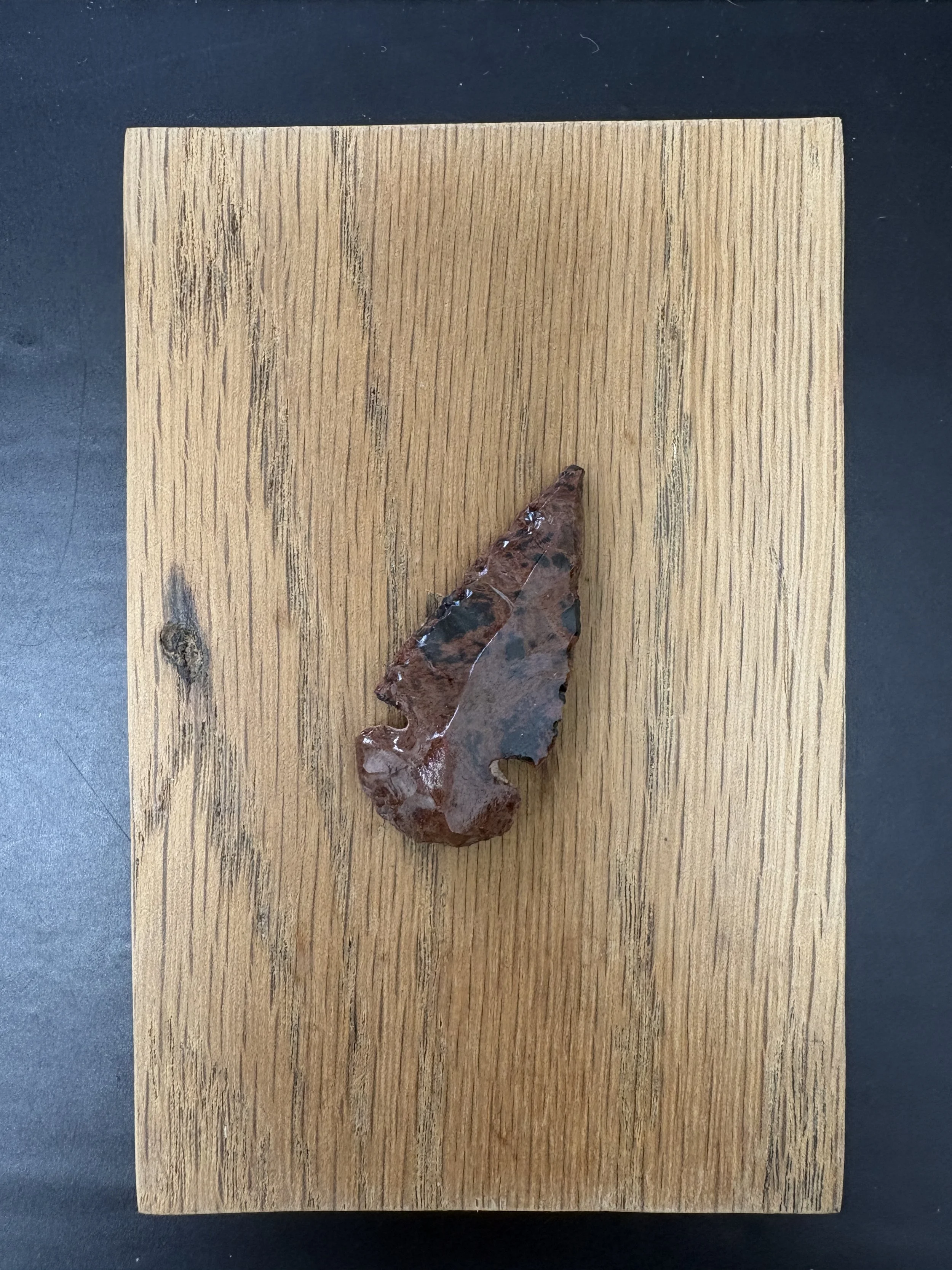 Obsidian Volcanic Glass in Arrowhead Shape on Oak Wall Plate
