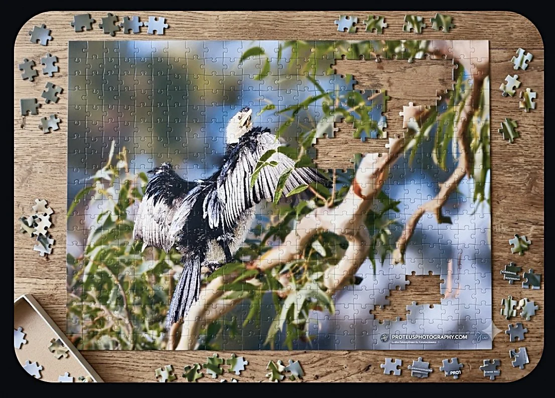 A partially completed jigsaw puzzle of a bird perching on a branch among leaves.