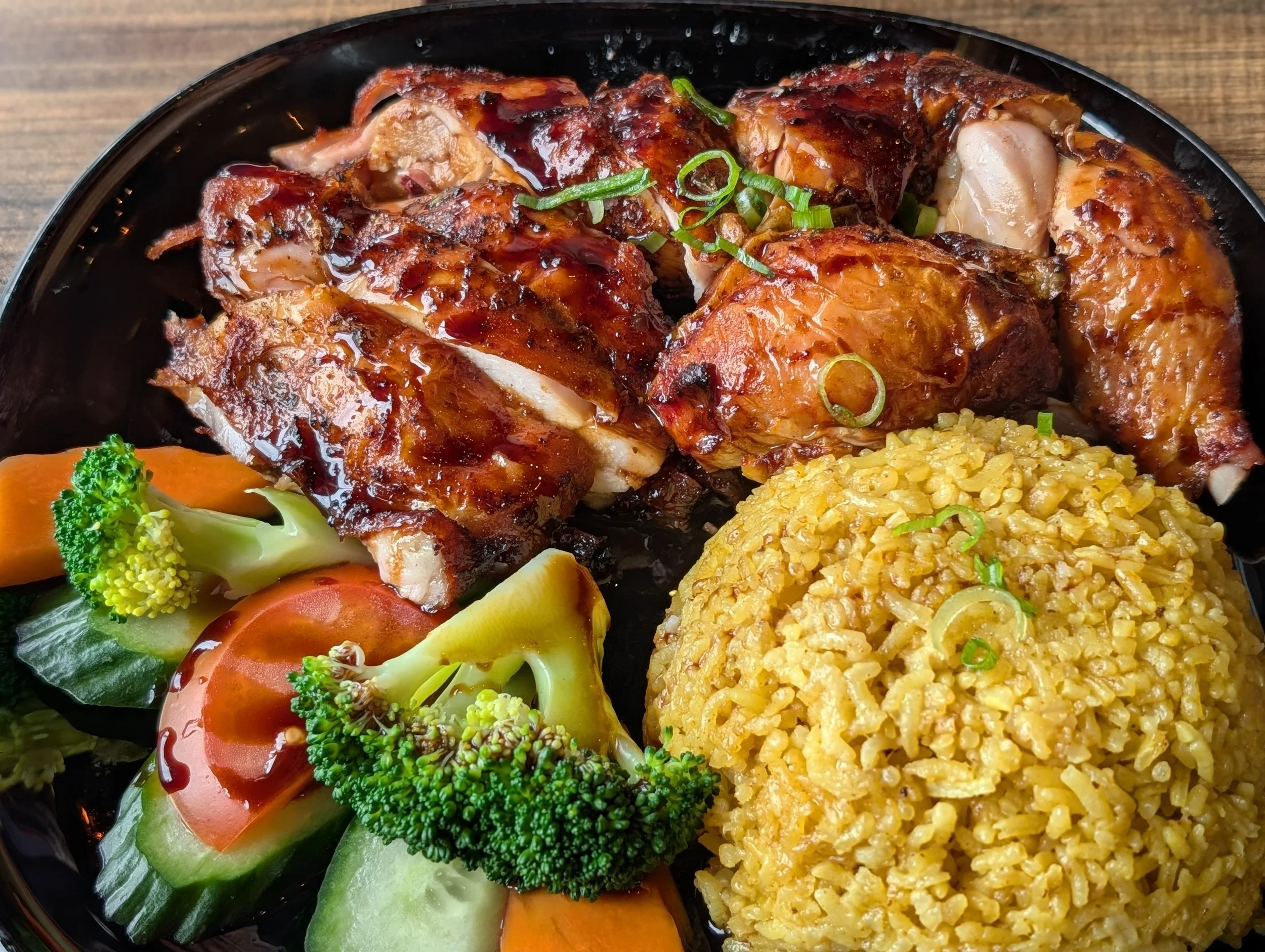 roasted chicken with a glazed, slightly caramelised, and crispy skin with aromatic, golden-yellow rice seasoned with turmeric